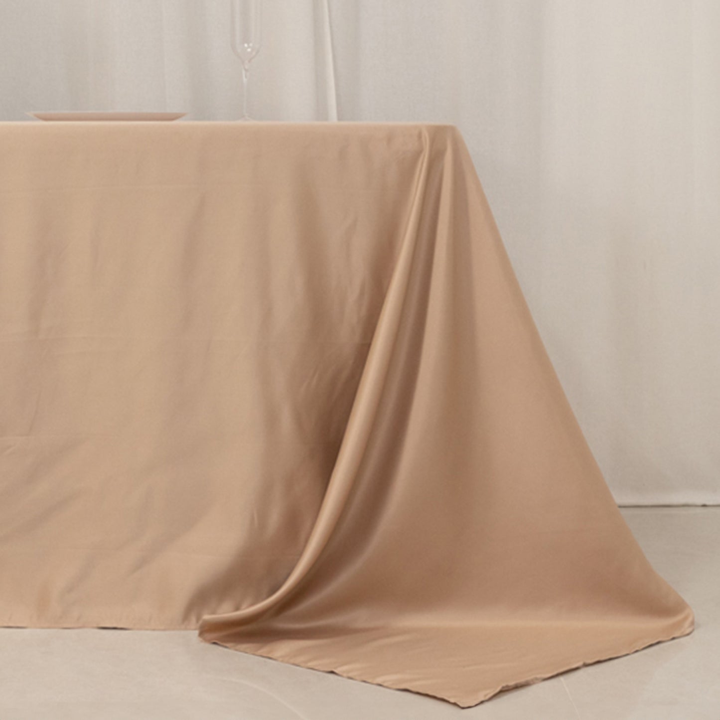 Nude seamless satin tablecloth for 8-foot table with floor-length drop.
