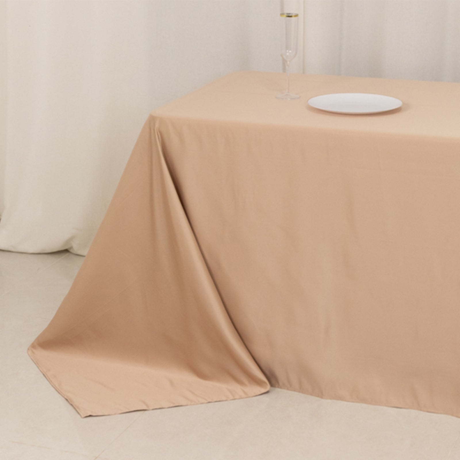 Nude seamless satin tablecloth for 8-foot table with floor-length drop.