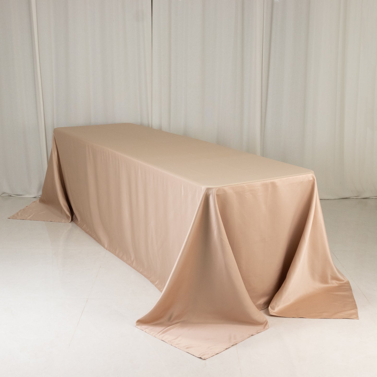 Nude seamless satin tablecloth for an 8-foot table with floor-length drop.