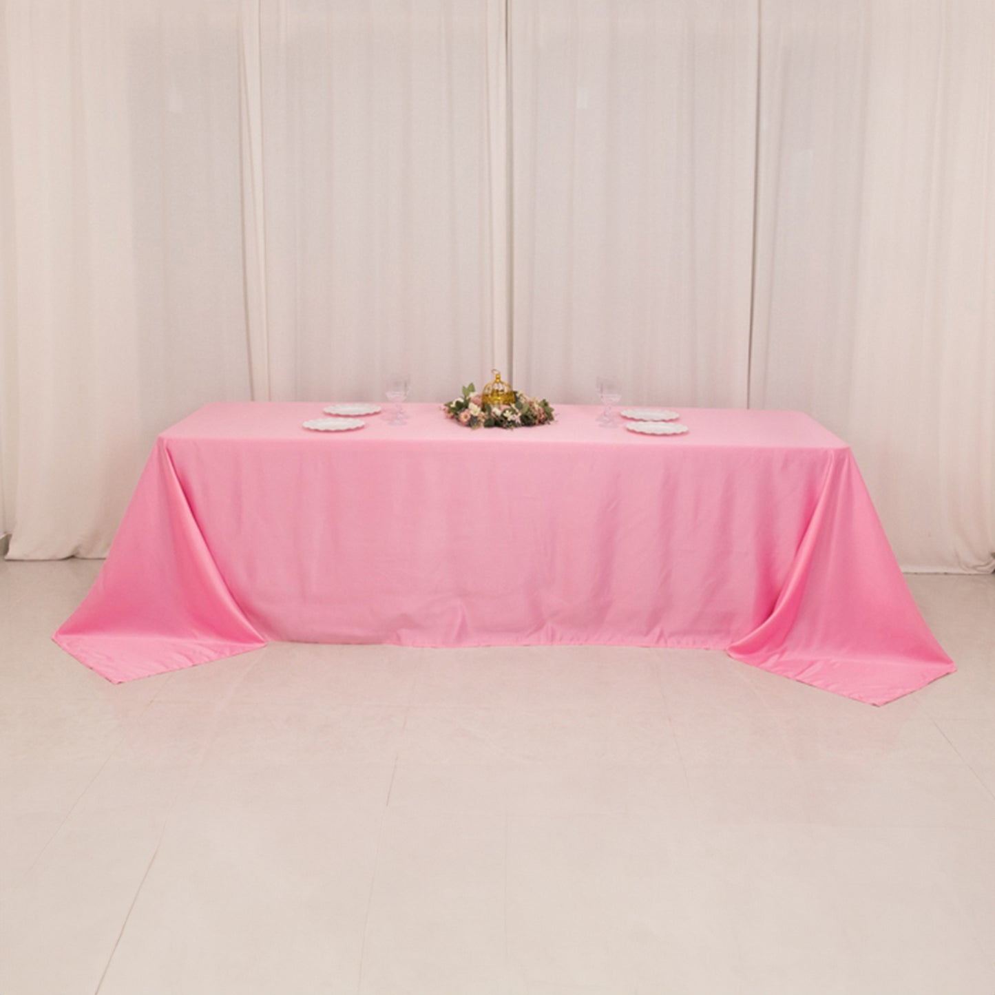 Pink satin tablecloth for 8-foot table with floor-length drop.
