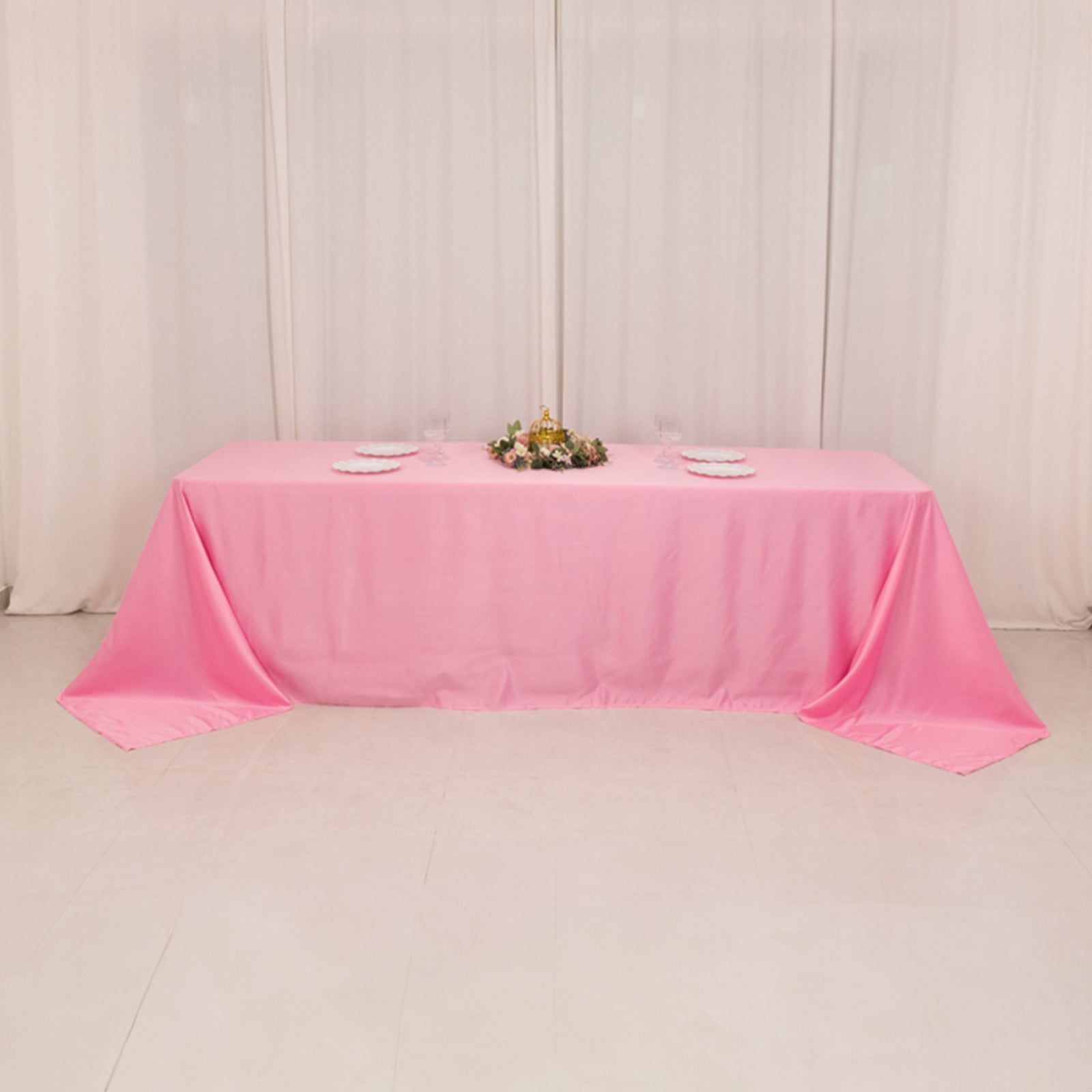 Pink satin tablecloth for 8-foot table with floor-length drop.