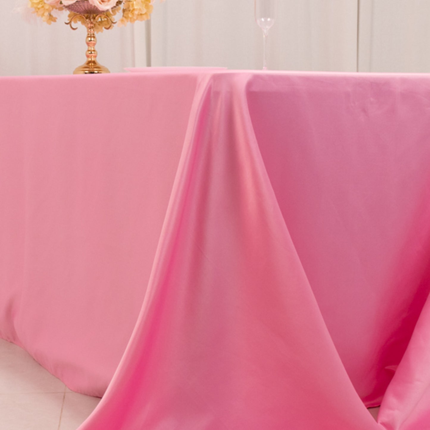 Pink satin tablecloth for 8-foot table with floor-length drop.