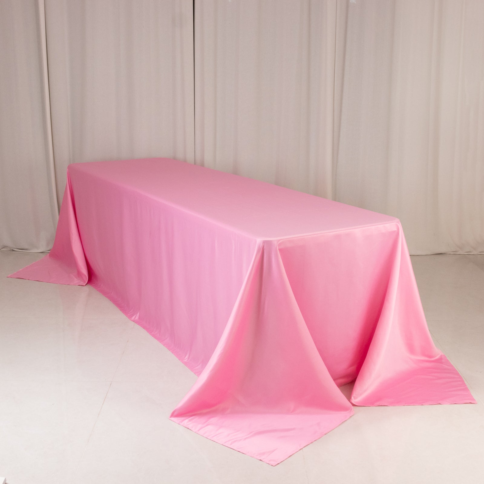 90"x156" pink satin tablecloth for 8-foot table with floor-length drop.