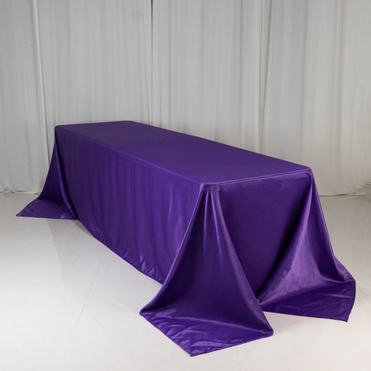 90"x156" purple satin tablecloth for 8-foot table with floor-length drop.