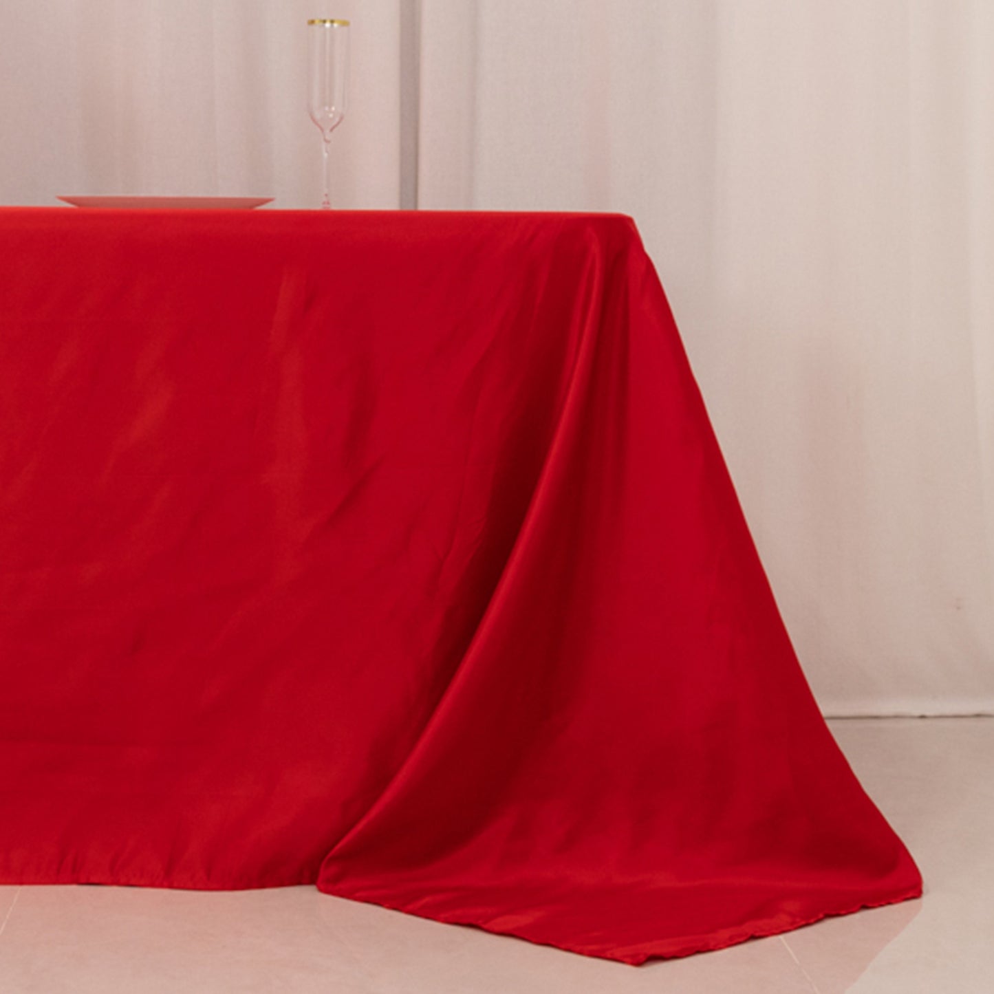 Red seamless satin tablecloth for 8-foot table with floor-length drop.