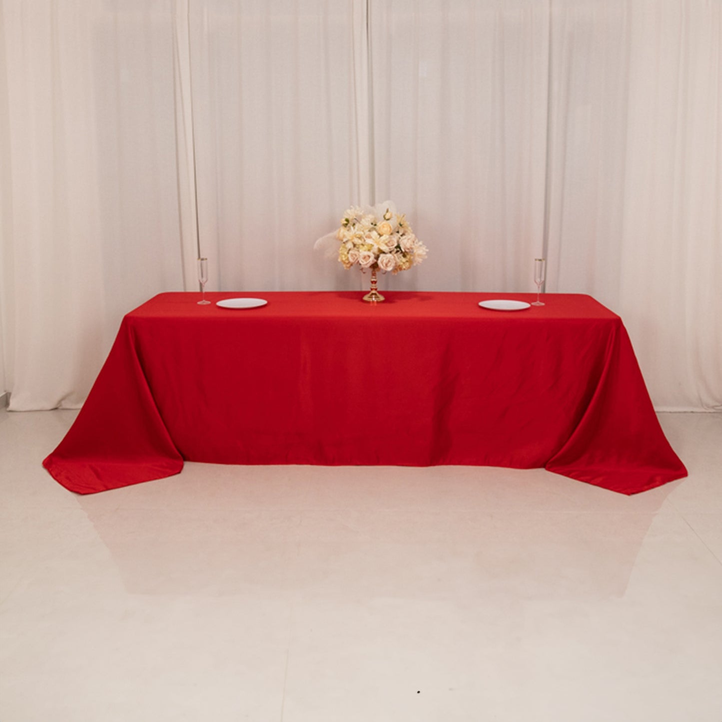 Red seamless satin tablecloth for 8-foot table with floor-length drop.