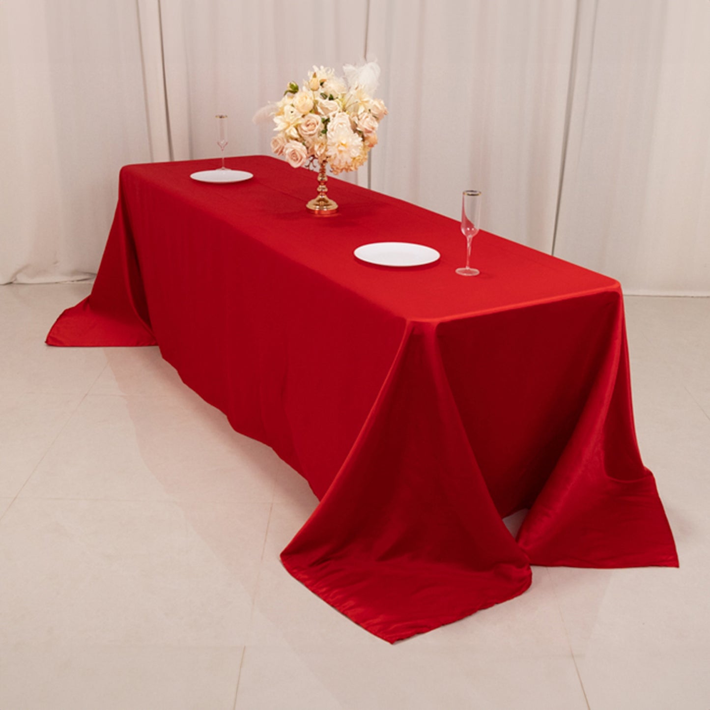 Red seamless satin tablecloth for 8-foot table with floor-length drop.