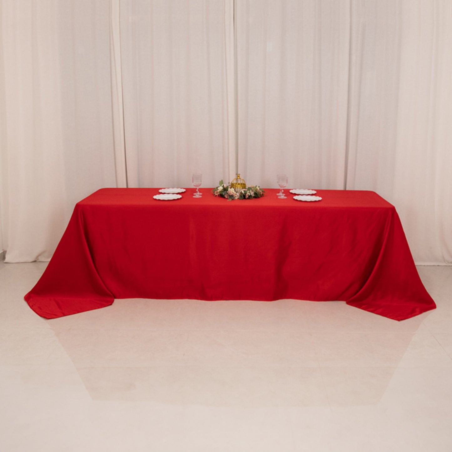 Red seamless satin tablecloth for 8-foot table with floor-length drop.