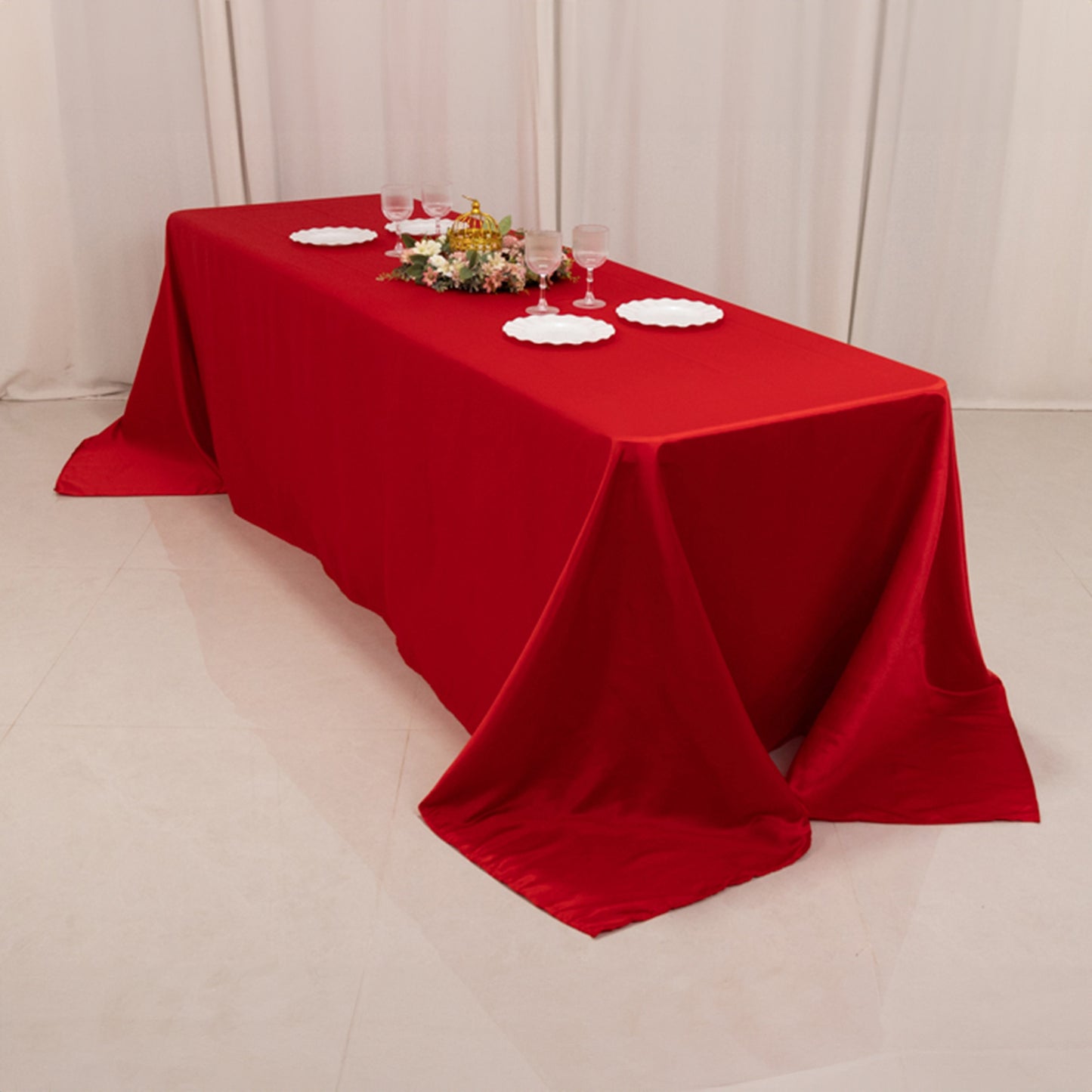 Red seamless satin tablecloth for 8-foot table with floor-length drop.