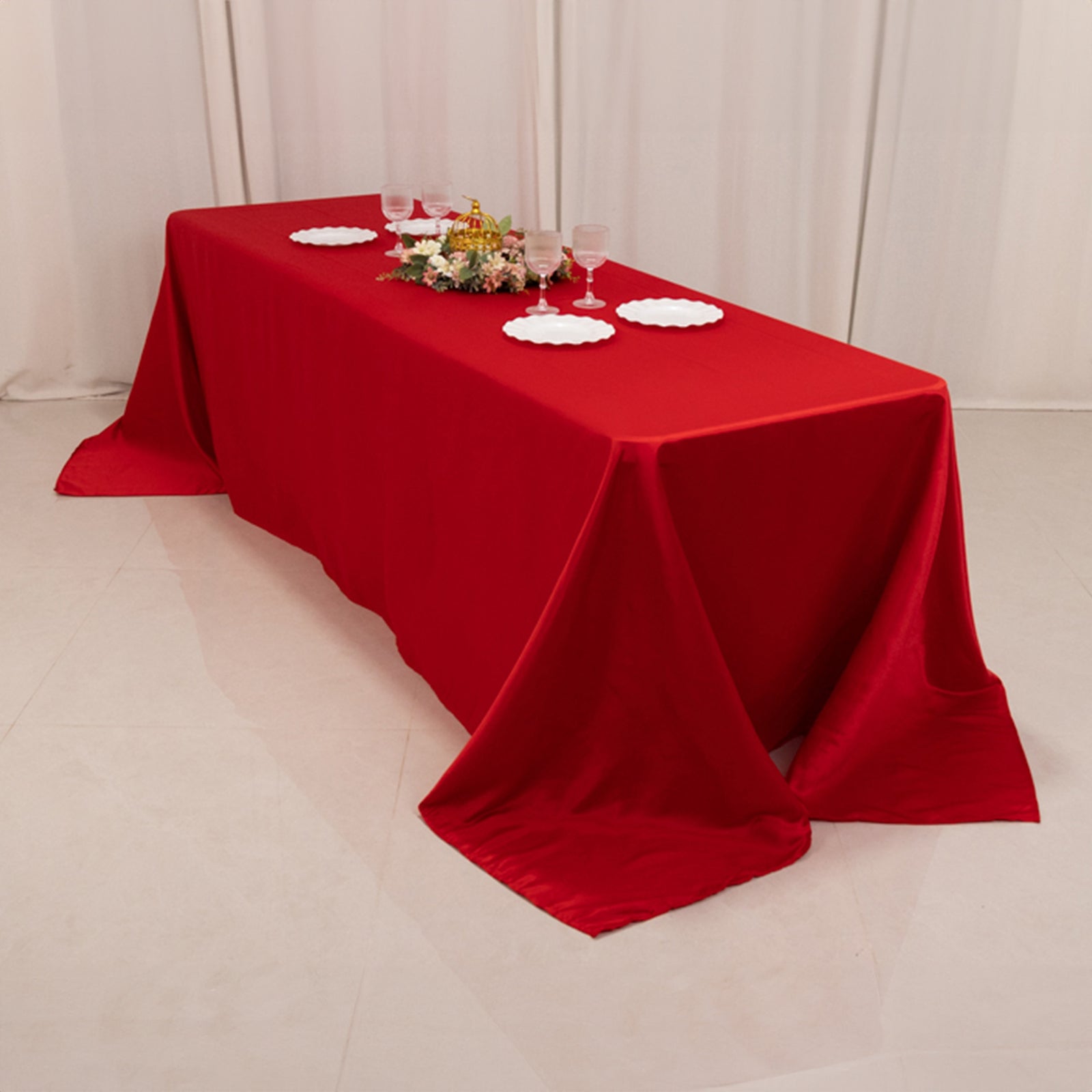 Red seamless satin tablecloth for 8-foot table with floor-length drop.