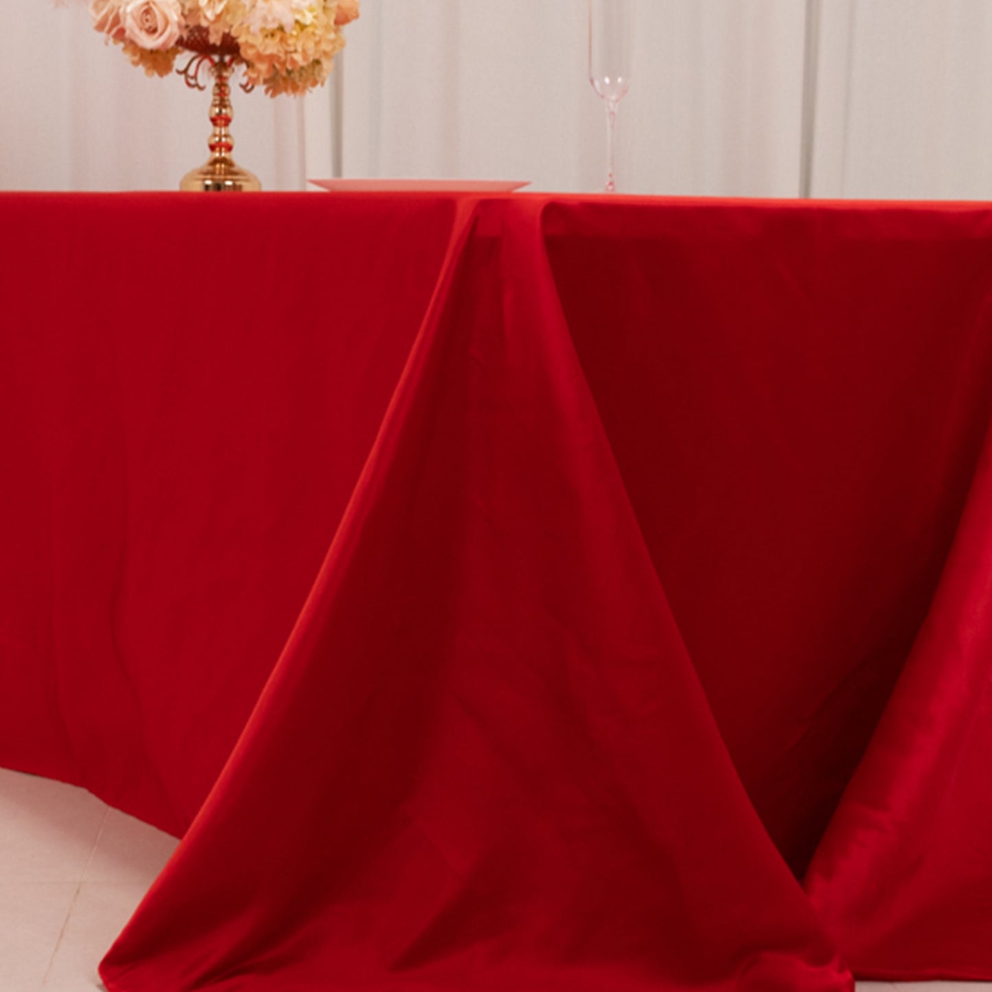 Red seamless satin tablecloth for 8-foot table with floor-length drop.