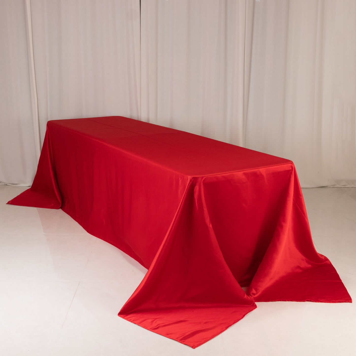 Red satin tablecloth for 8-foot table with floor-length drop.