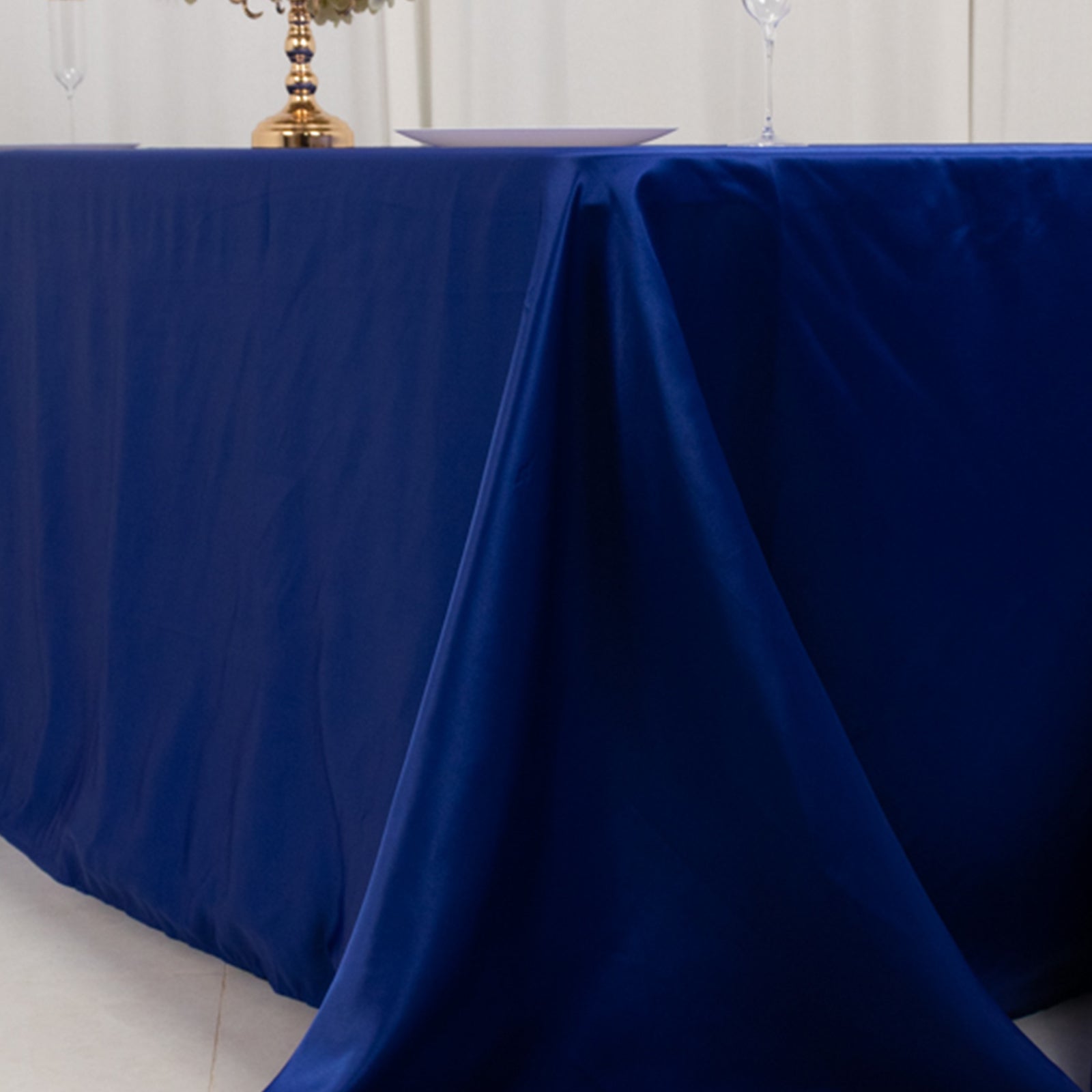Royal blue satin tablecloth draping elegantly over an 8-foot table.