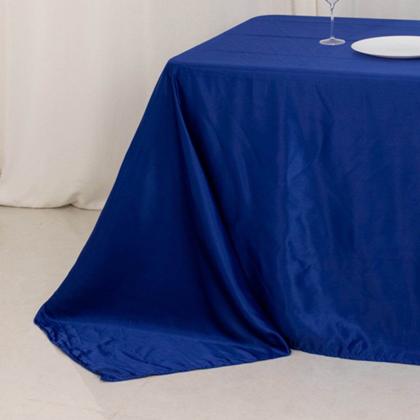 Royal blue seamless satin tablecloth for 8-foot table with floor-length drop.
