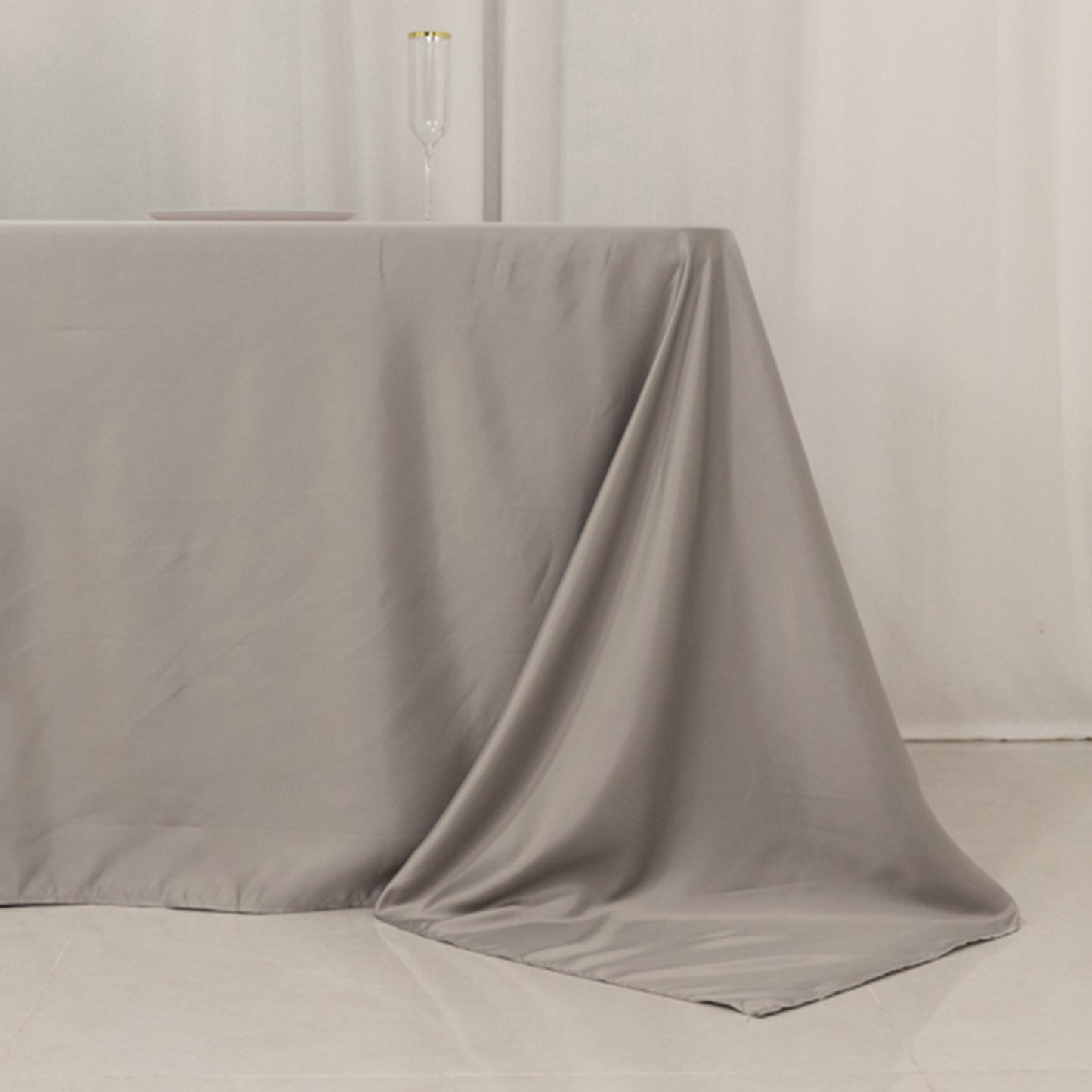 Silver rectangular tablecloth for 8-foot table with floor-length drop.