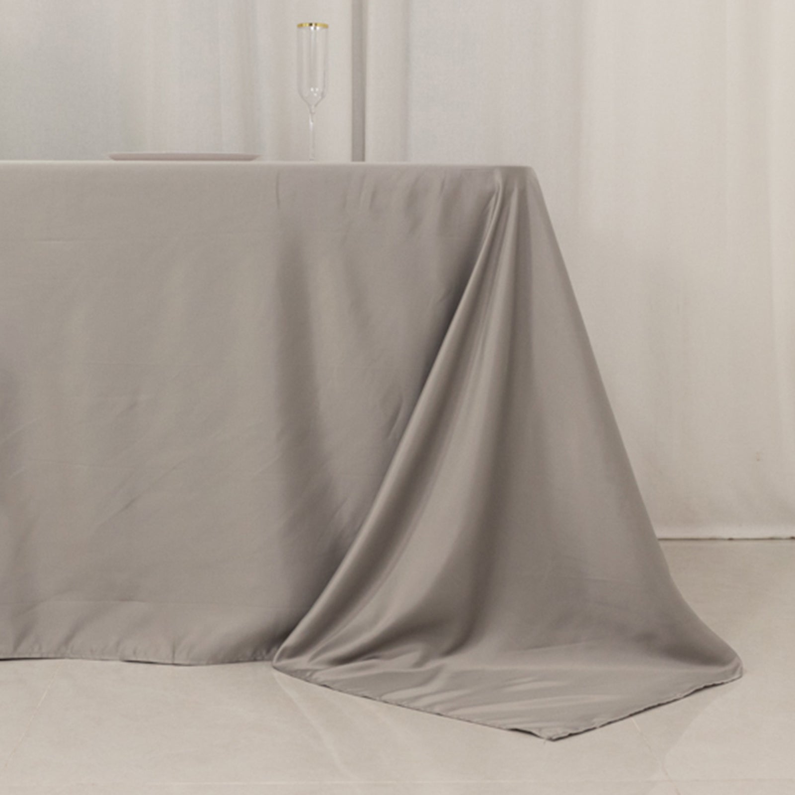 Silver rectangular tablecloth for 8-foot table with floor-length drop.