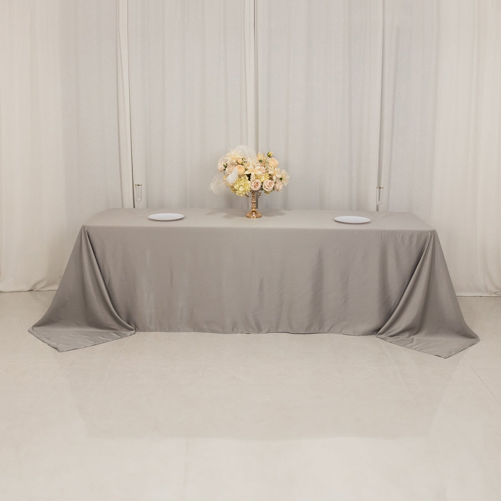 Silver satin tablecloth for 8-foot table with floor-length drop.