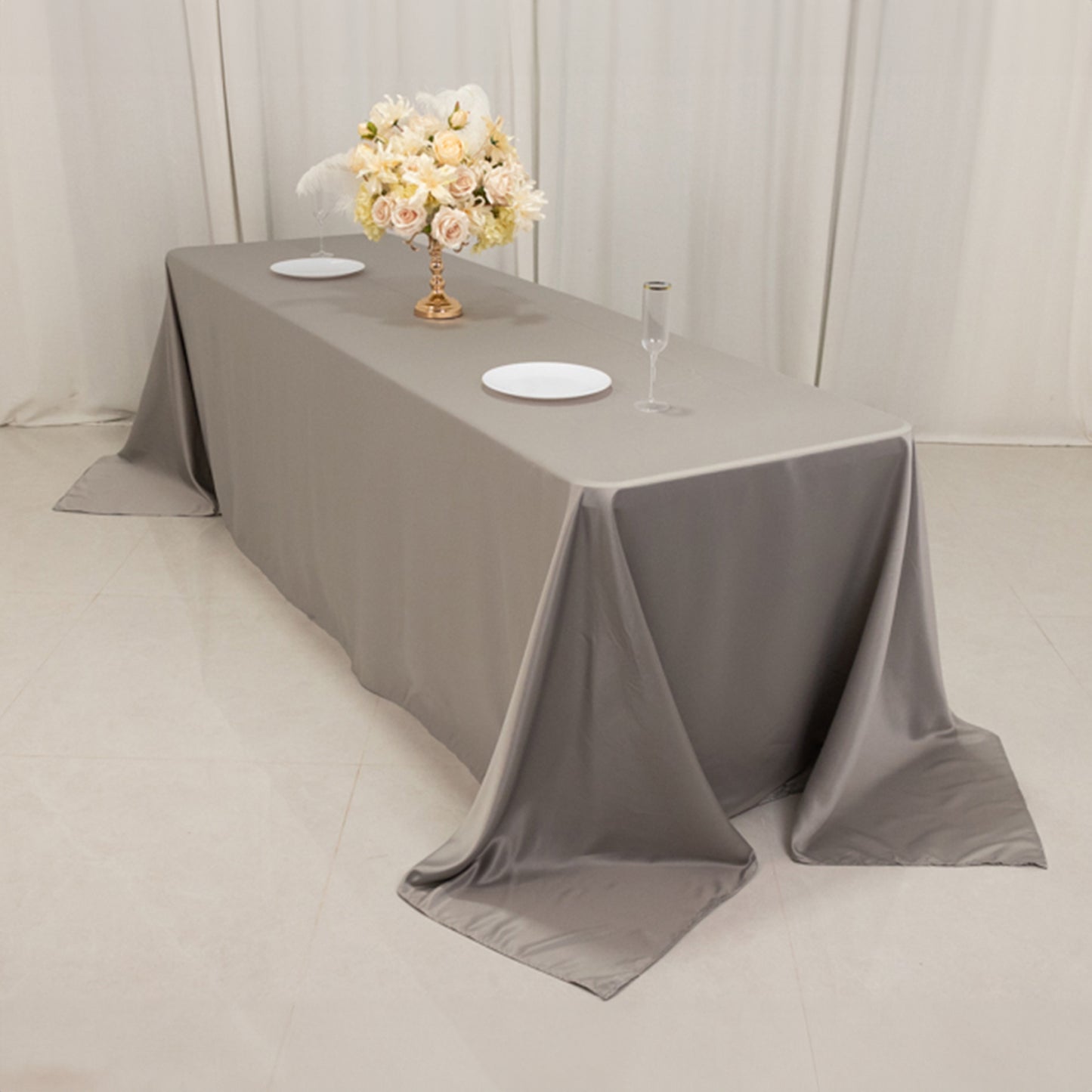 Silver seamless satin tablecloth for 8-foot table with floor-length drop.