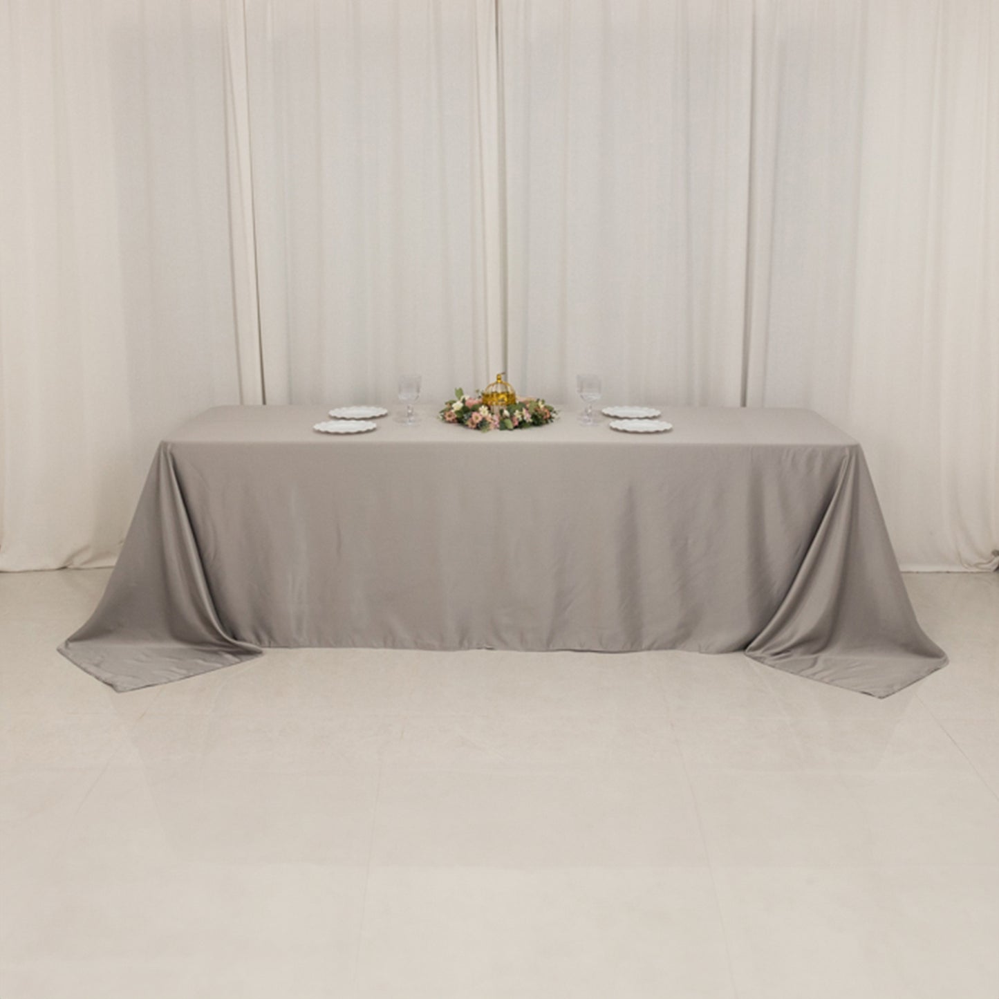 Silver satin tablecloth for 8-foot table with floor-length drop.