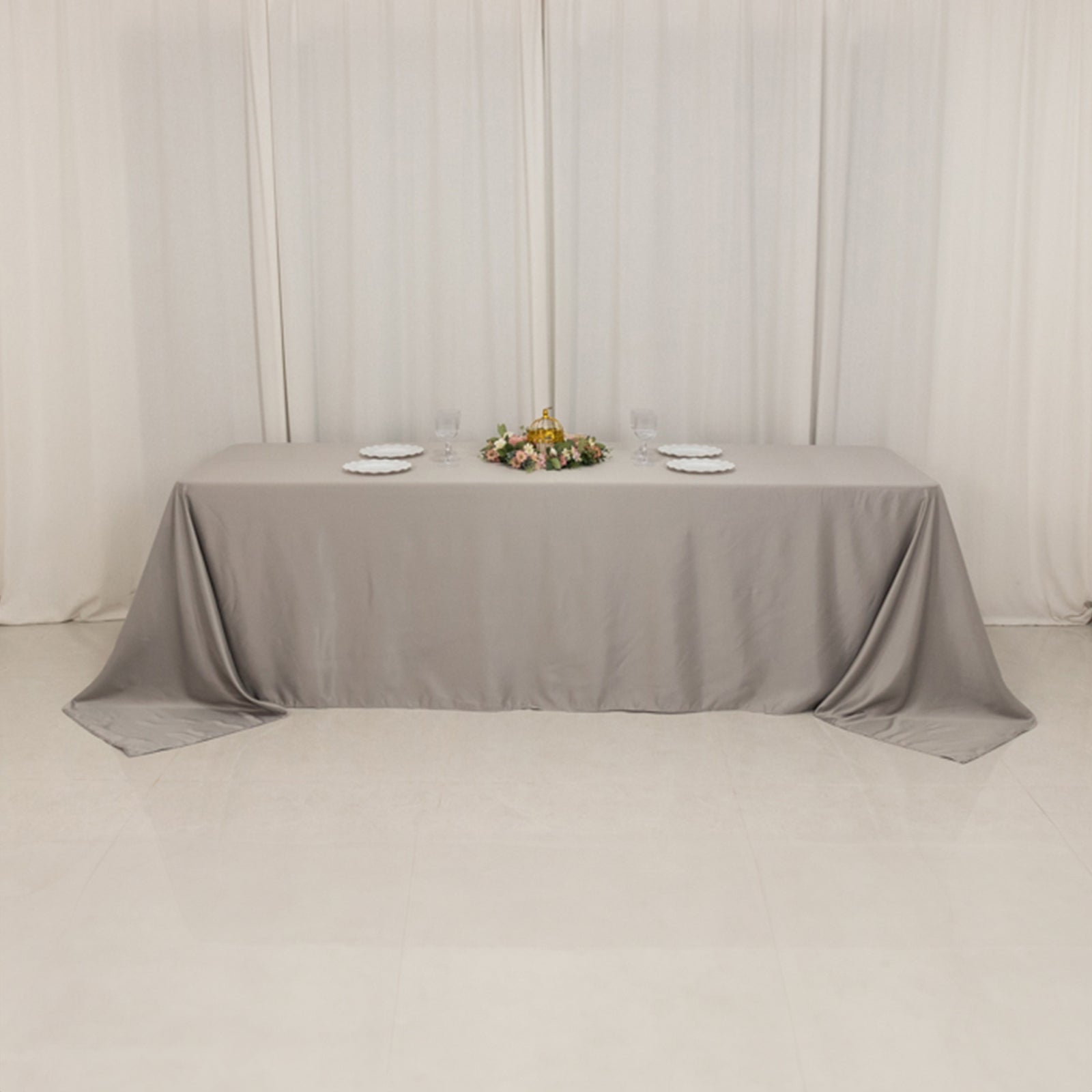 Silver satin tablecloth for 8-foot table with floor-length drop.