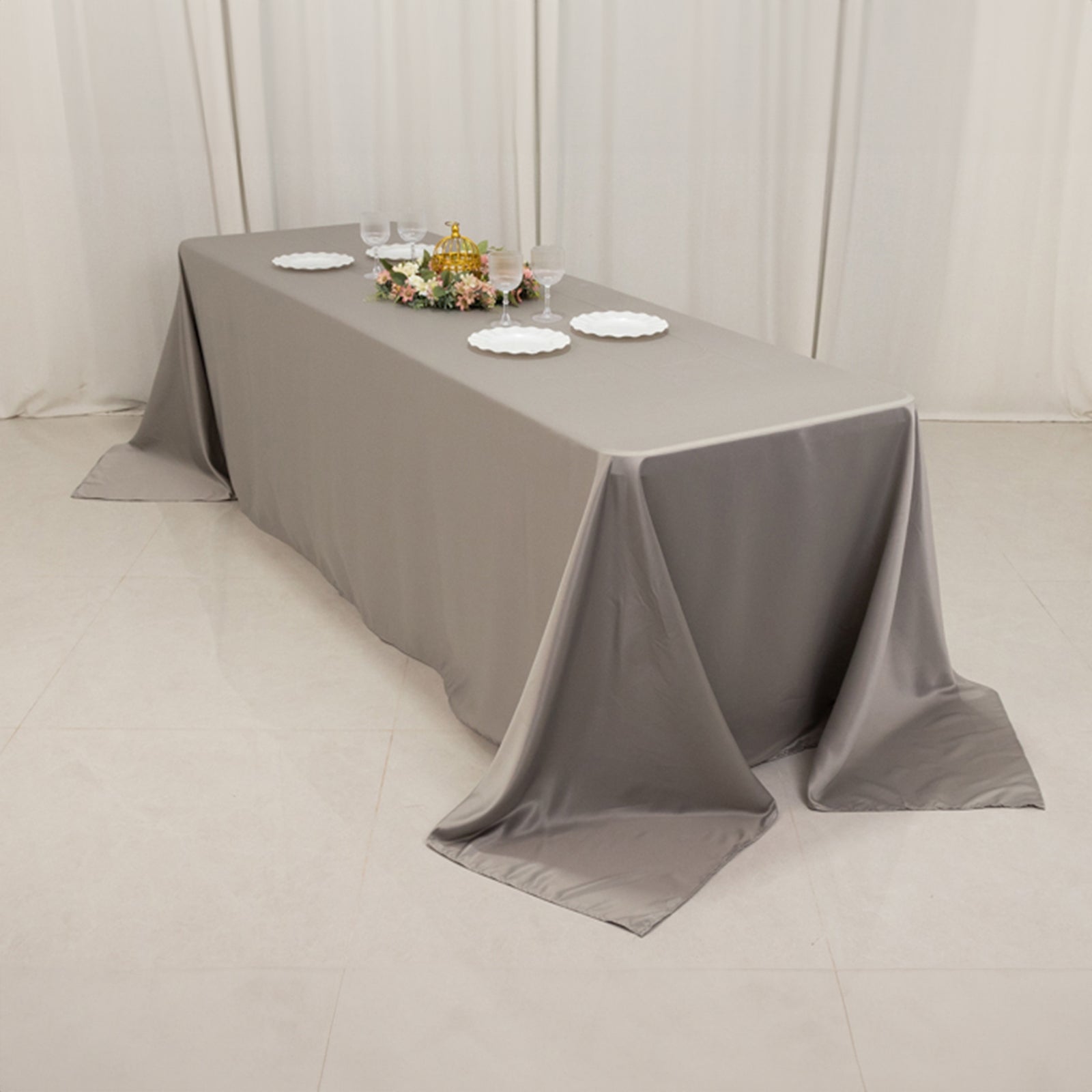 Silver satin tablecloth for 8 foot table with floor-length drop.
