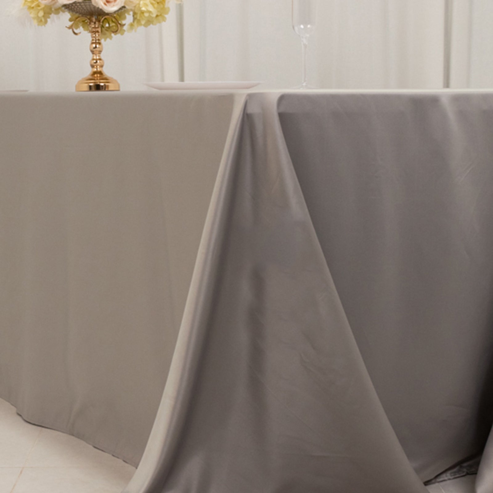 Silver seamless satin tablecloth for 8-foot table with floor-length drop.