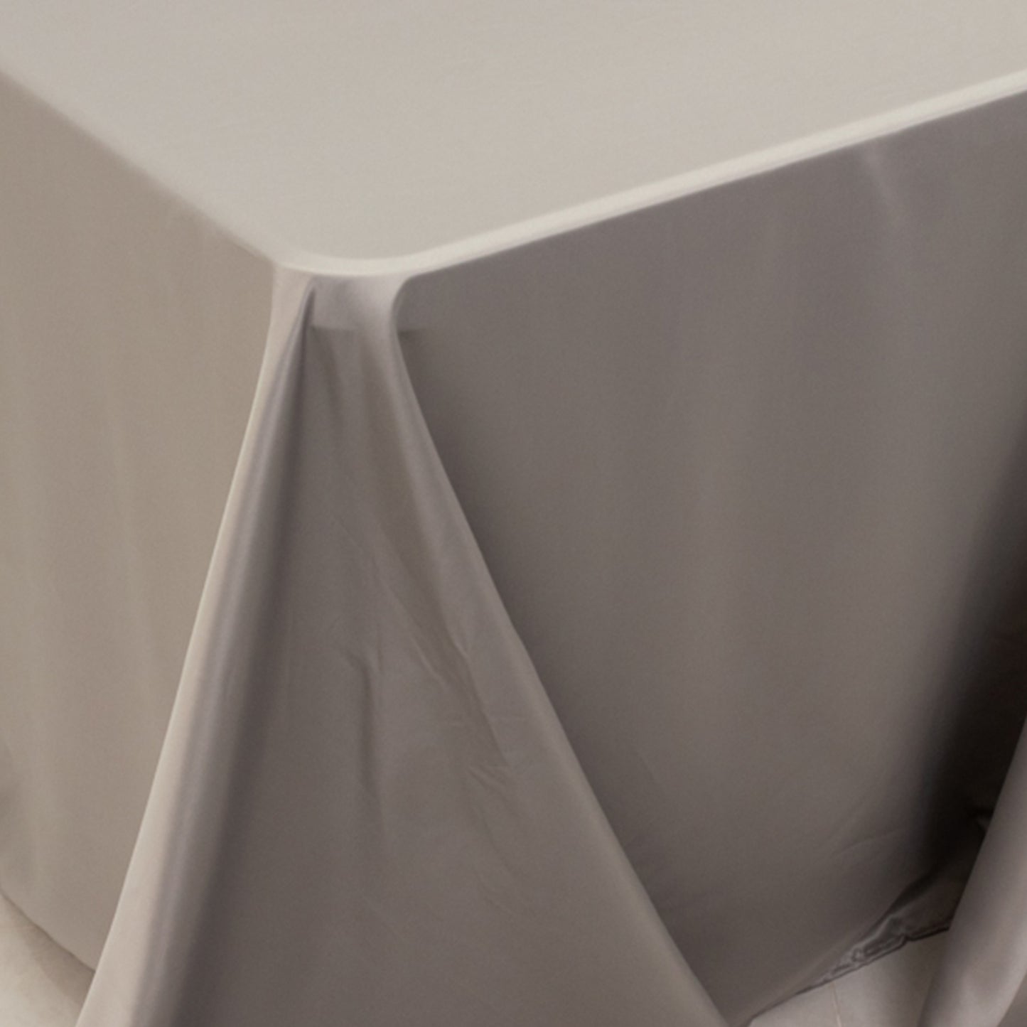 Silver satin tablecloth for 8-foot table with floor-length drop.