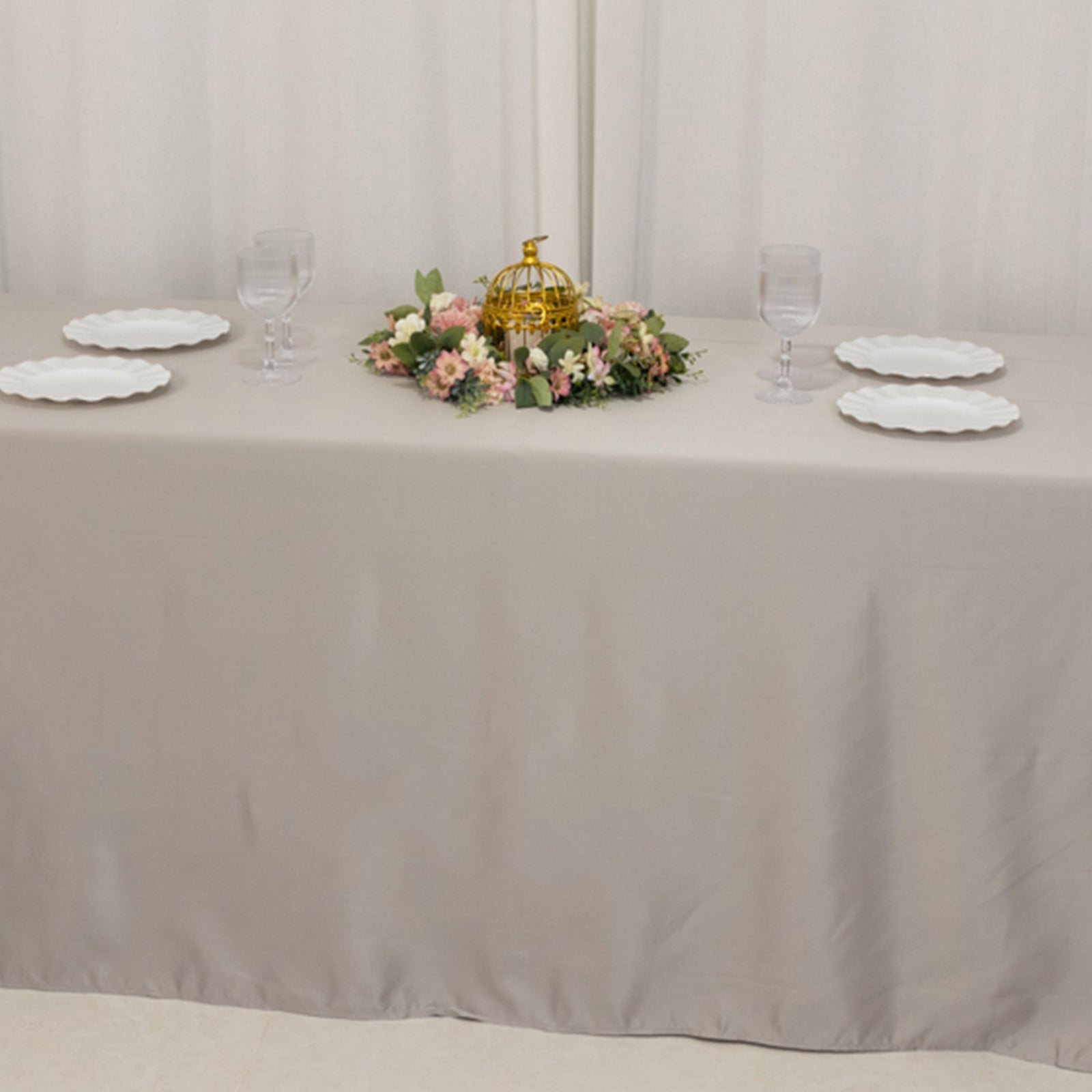 Silver seamless satin tablecloth for 8-foot table with floor-length drop.