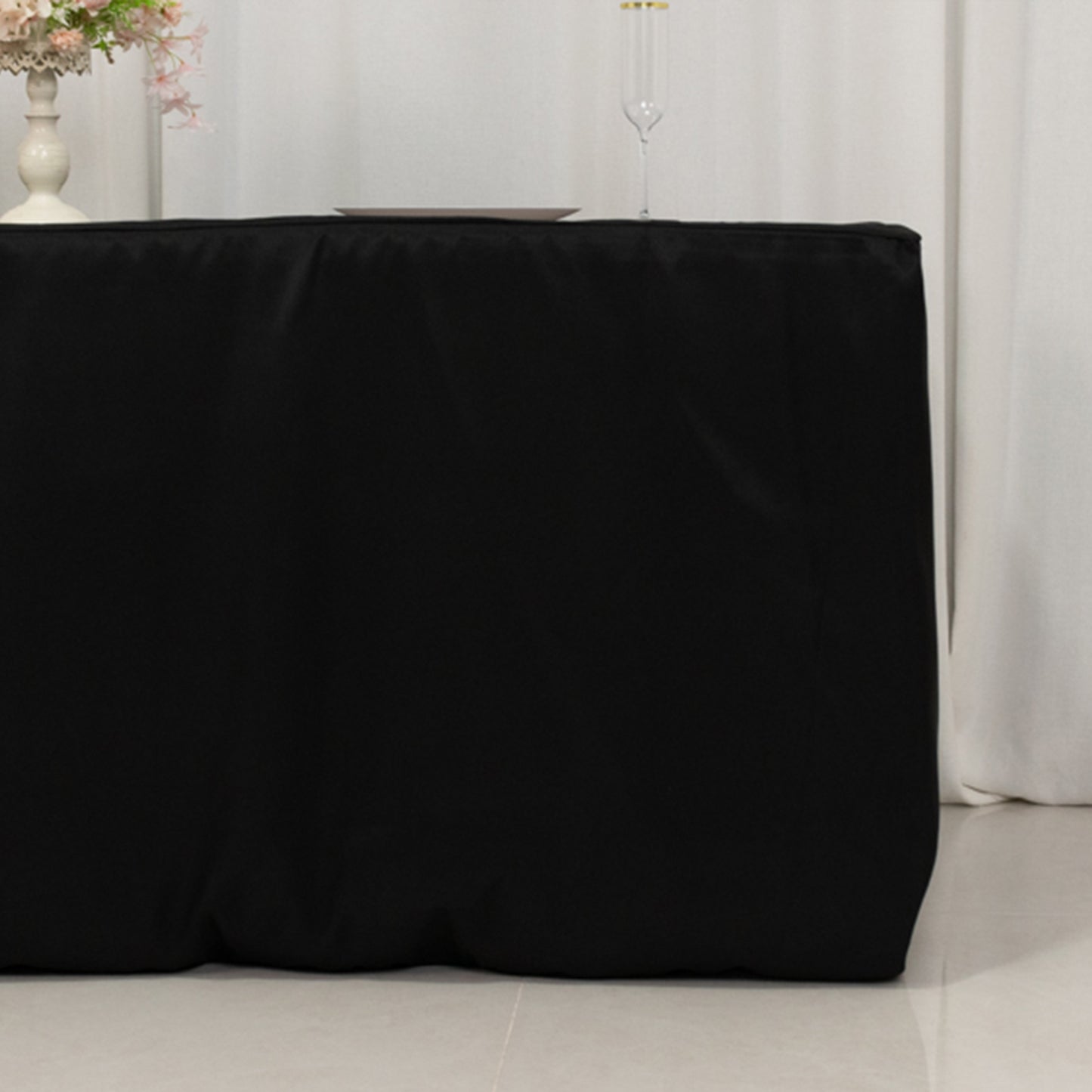 Black fitted premium polyester tablecloth for 72"x30" tables.