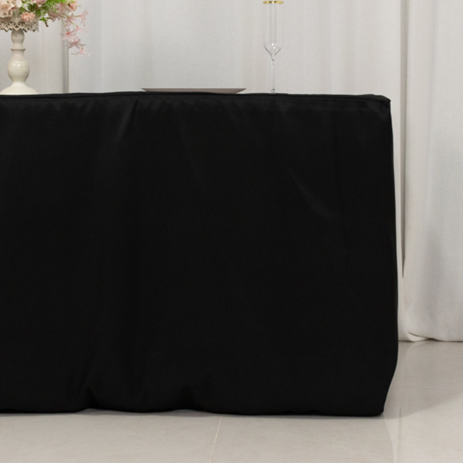 Black fitted premium polyester tablecloth for 72"x30" tables.