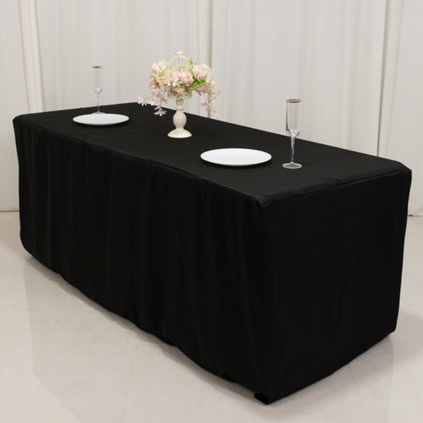 Black fitted tablecloth for 72"x30" tables, perfect for events and gatherings.