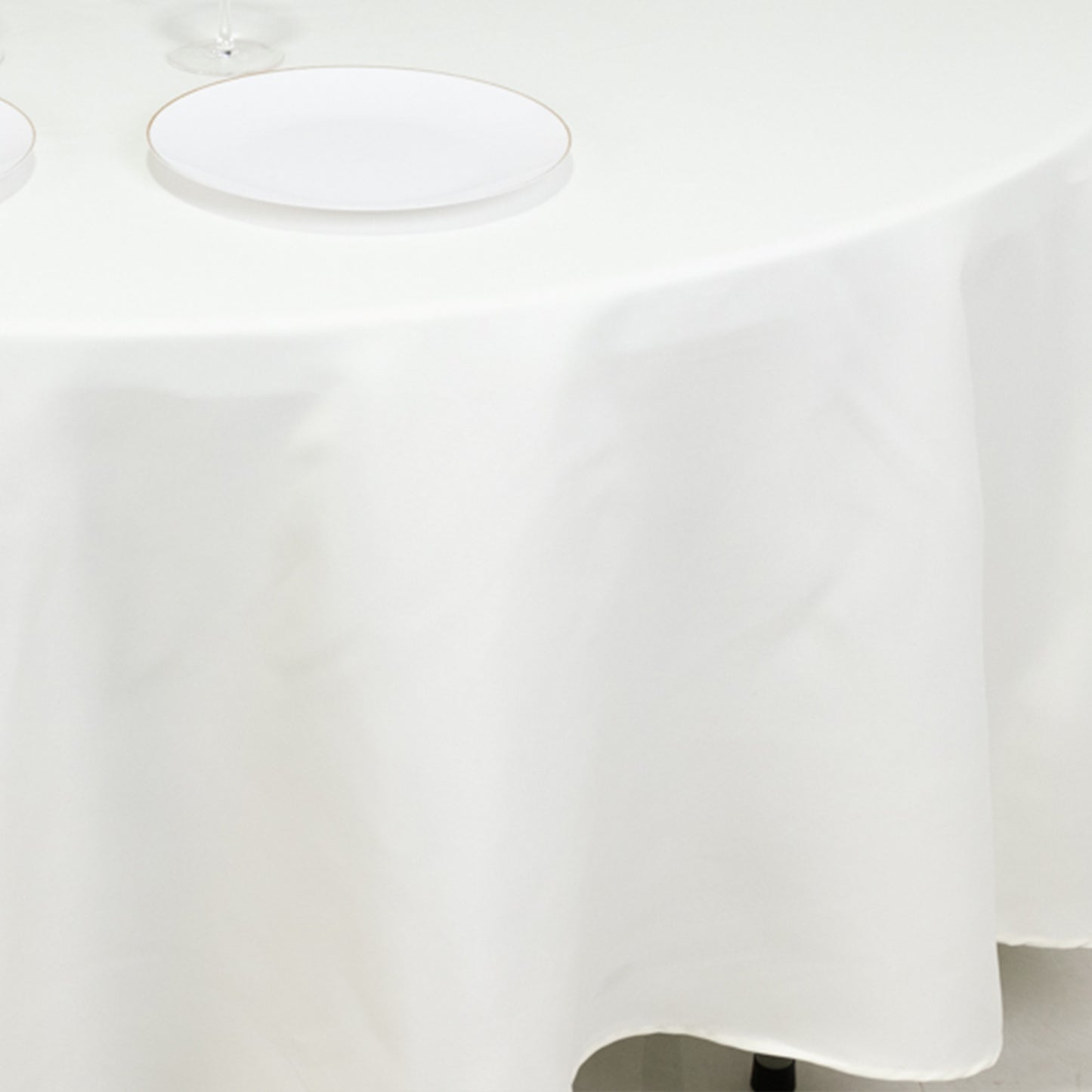 Ivory fire retardant round tablecloth on a dining table.
