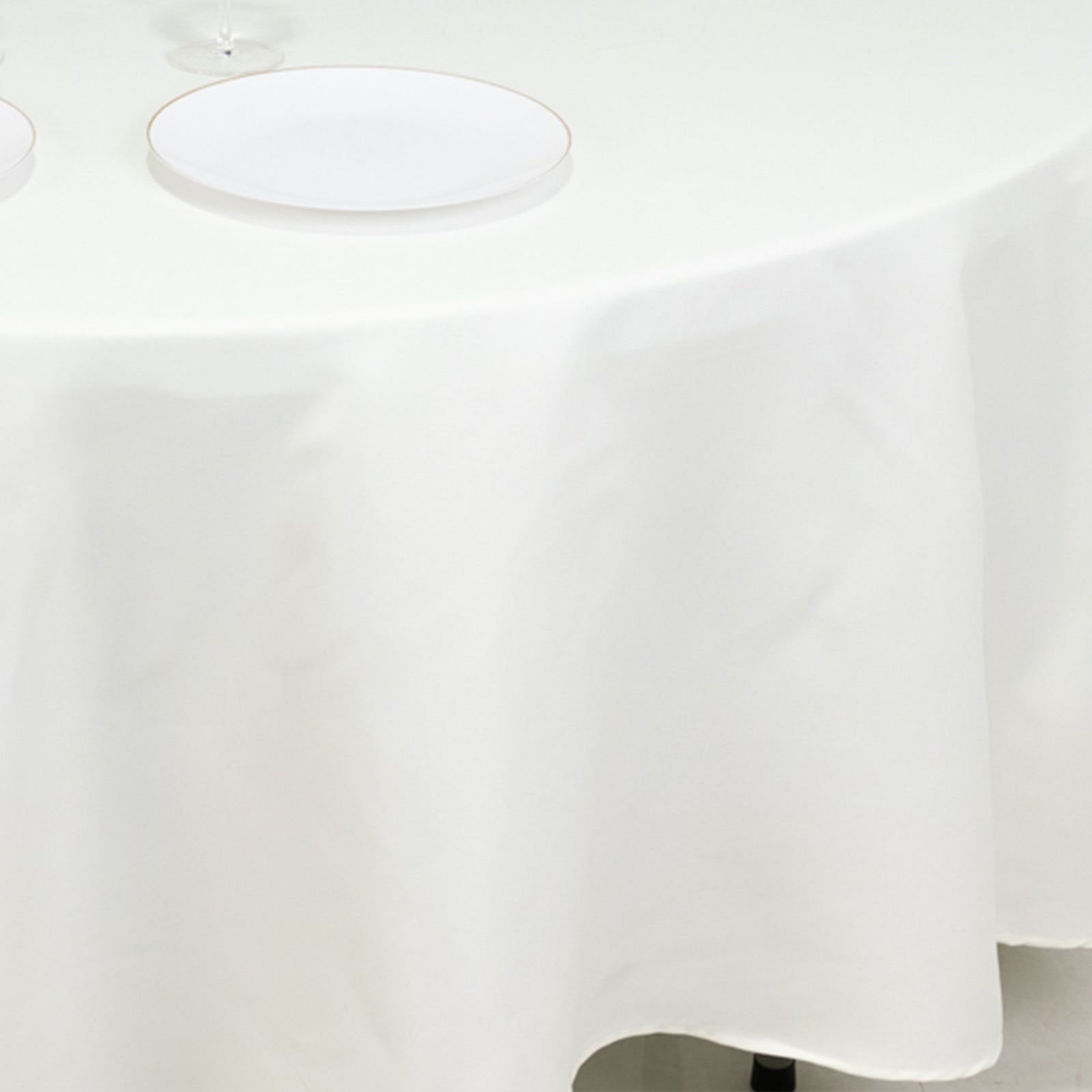 Ivory fire retardant round tablecloth on a dining table.