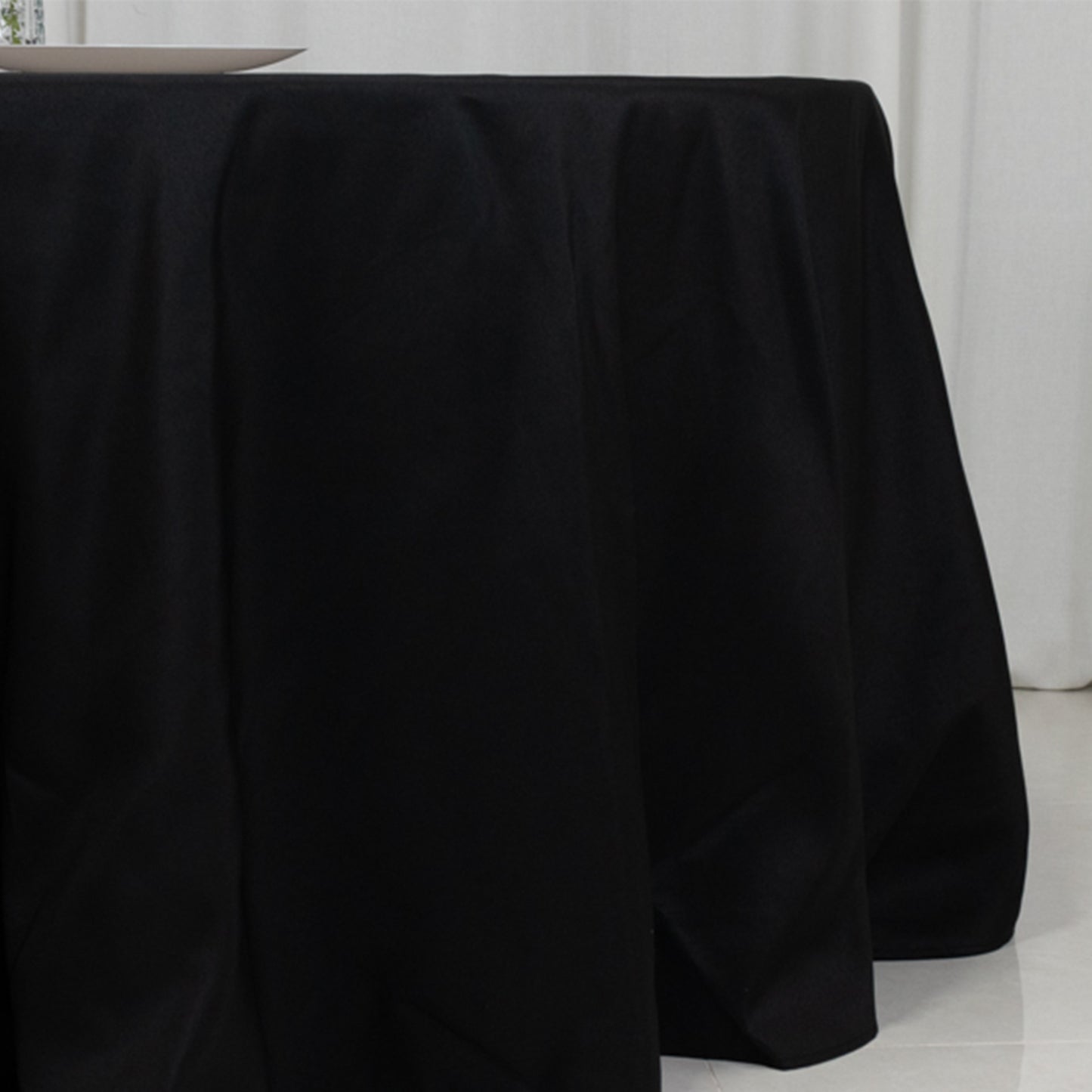 Black fire retardant tablecloth for a 5-foot round table with floor-length drop.
