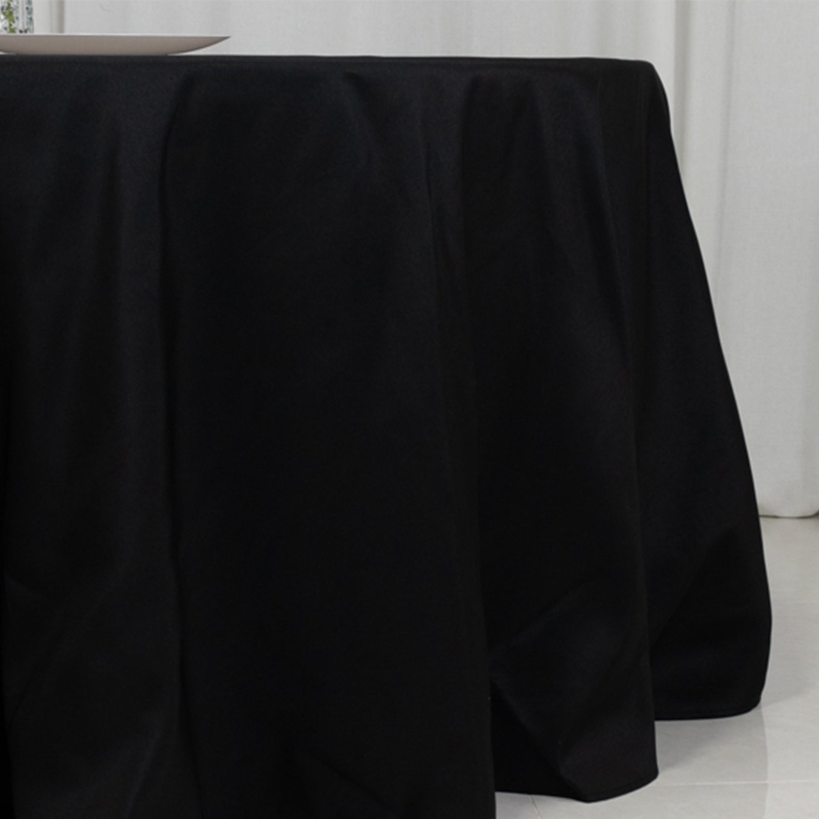 Black fire retardant tablecloth for a 5-foot round table with floor-length drop.