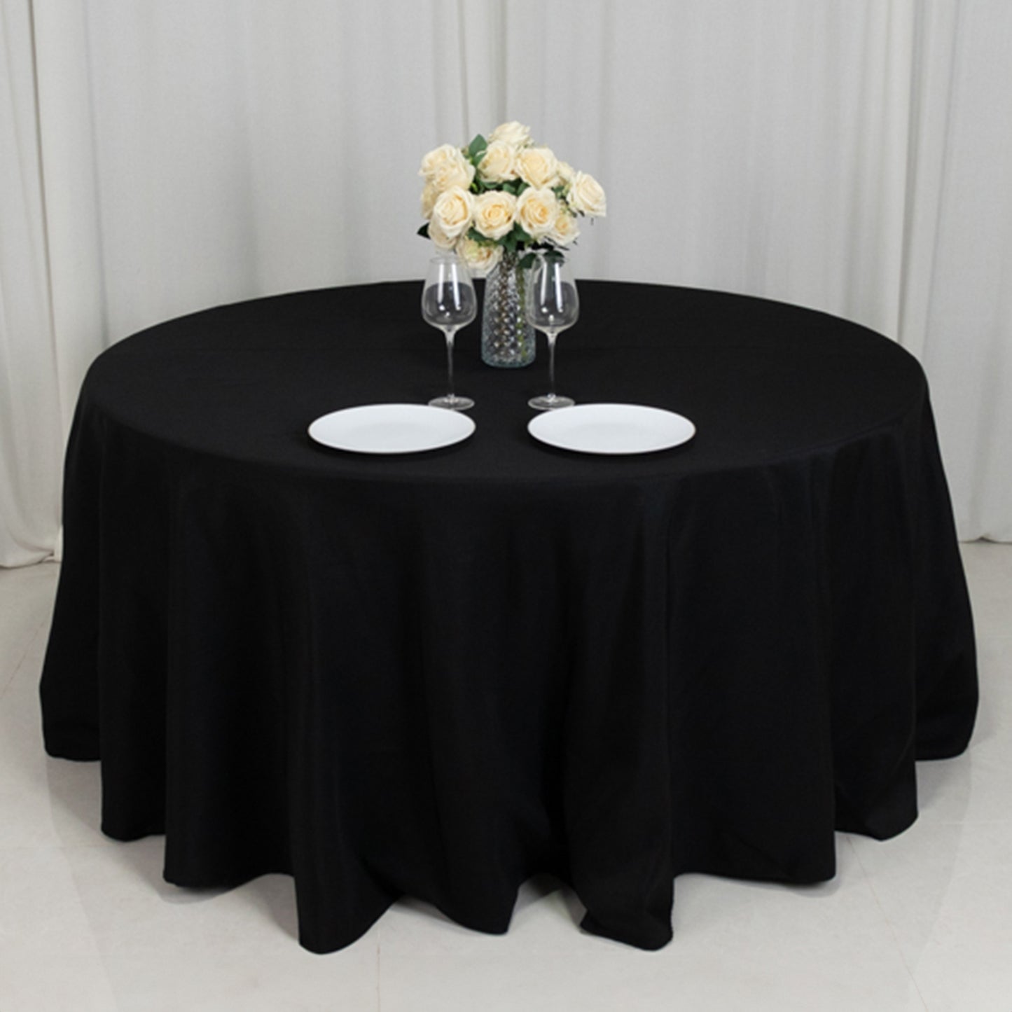 Black round table cover for a 5-foot table with floor-length drop.