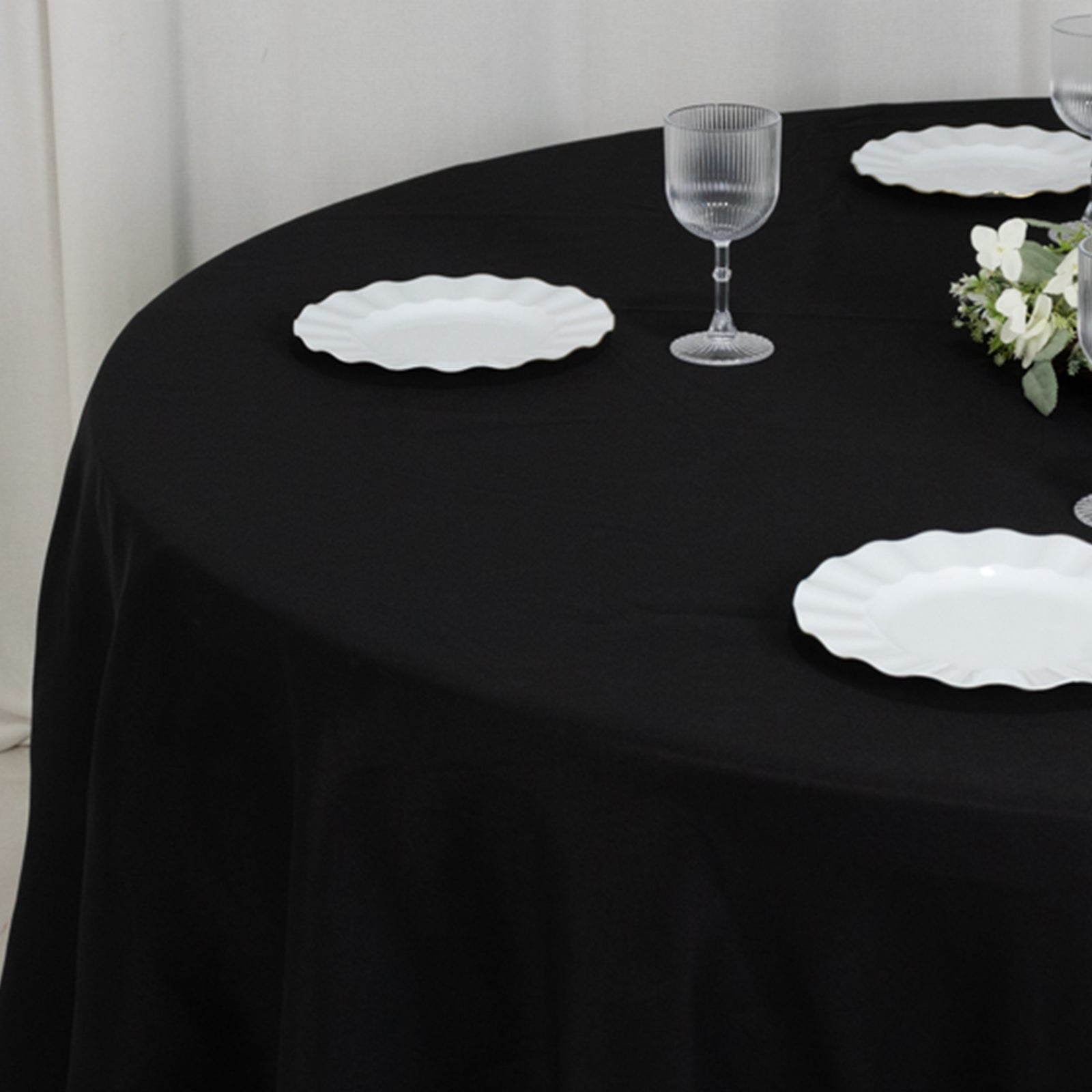 Black seamless round table cover for a 5-foot table with floor-length drop.
