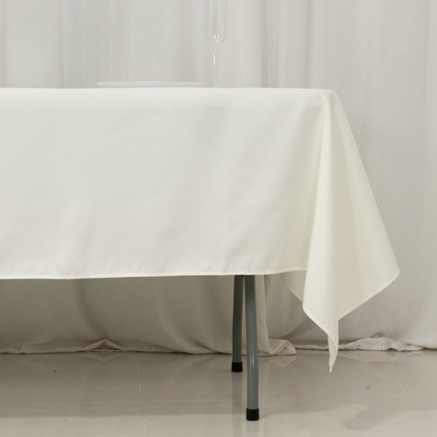 Ivory fire retardant polyester tablecloth on a rectangular table.