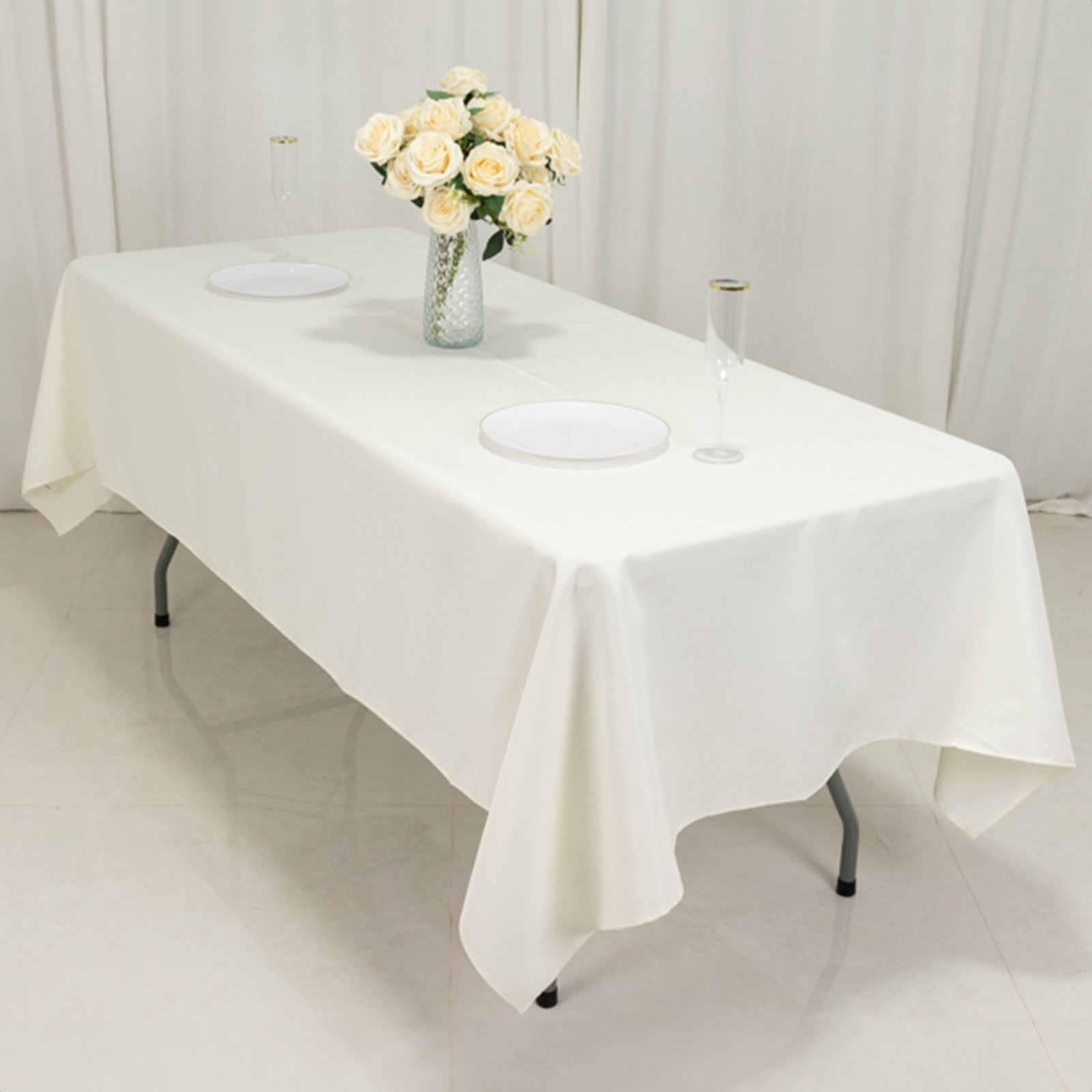 Ivory fire retardant polyester rectangular tablecloth on a dining table.