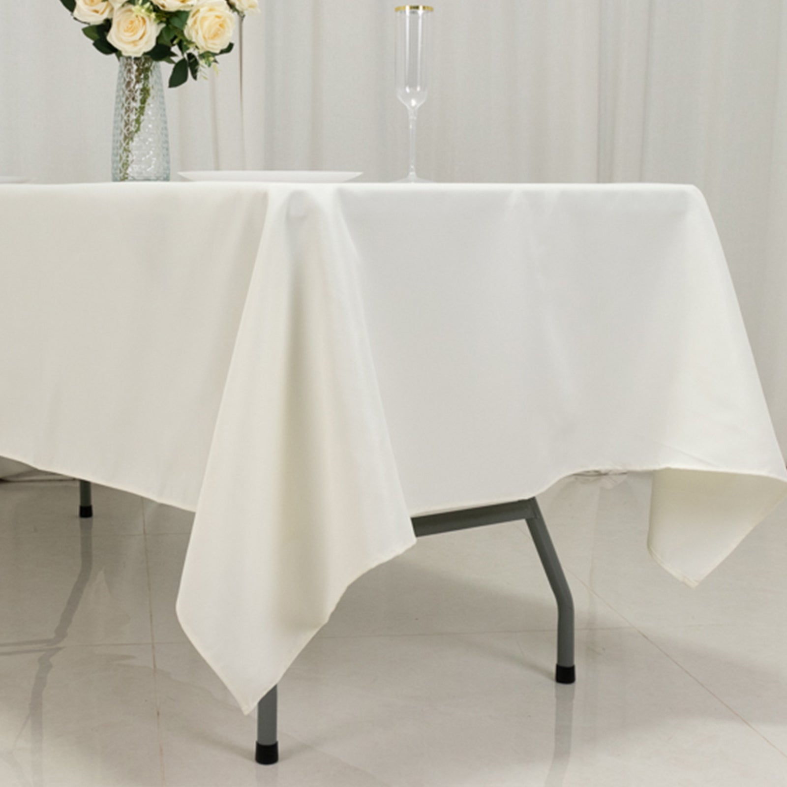 Ivory fire retardant polyester tablecloth on a rectangular table.