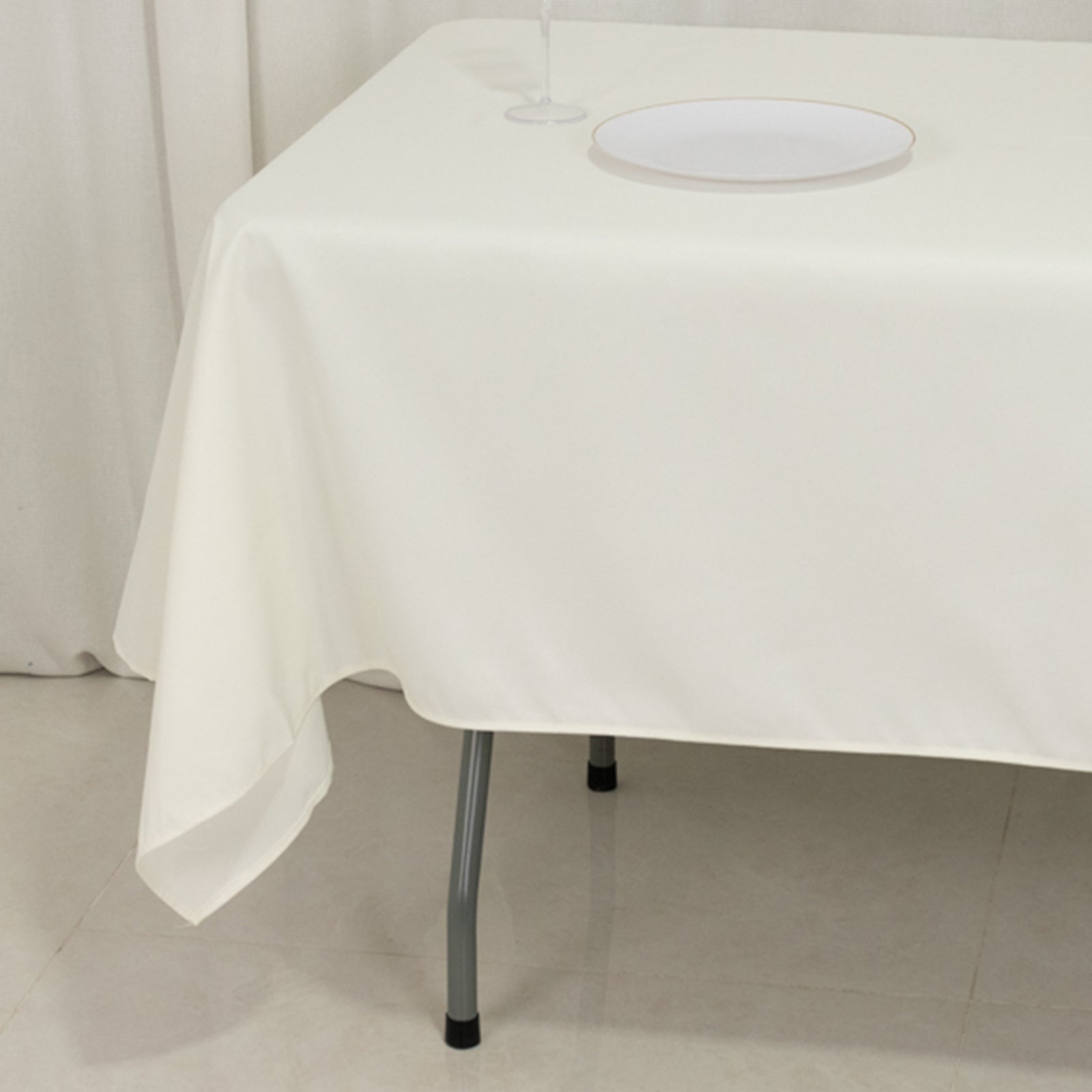 Ivory fire retardant tablecloth on a rectangular table.