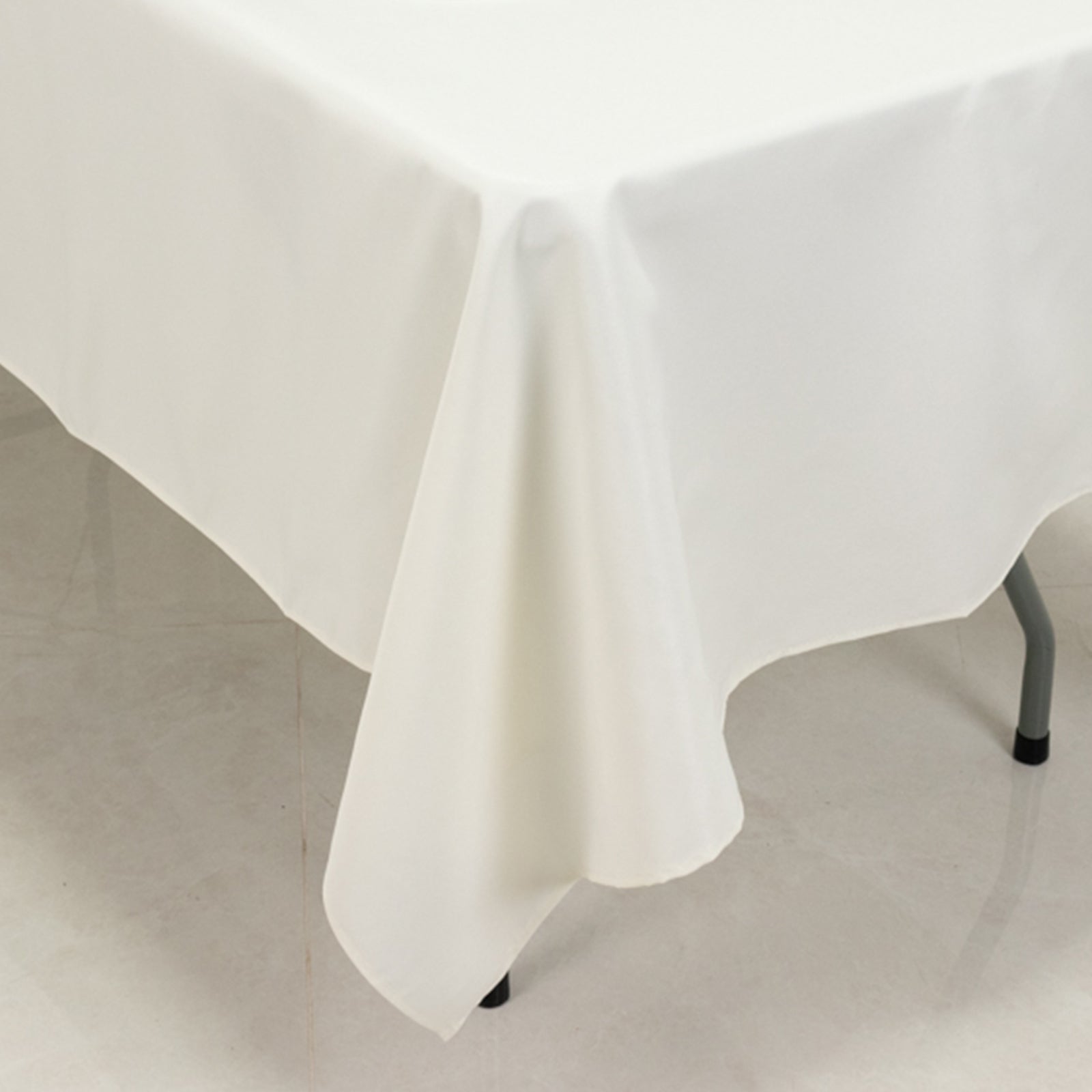 Ivory fire retardant polyester tablecloth for rectangular tables.