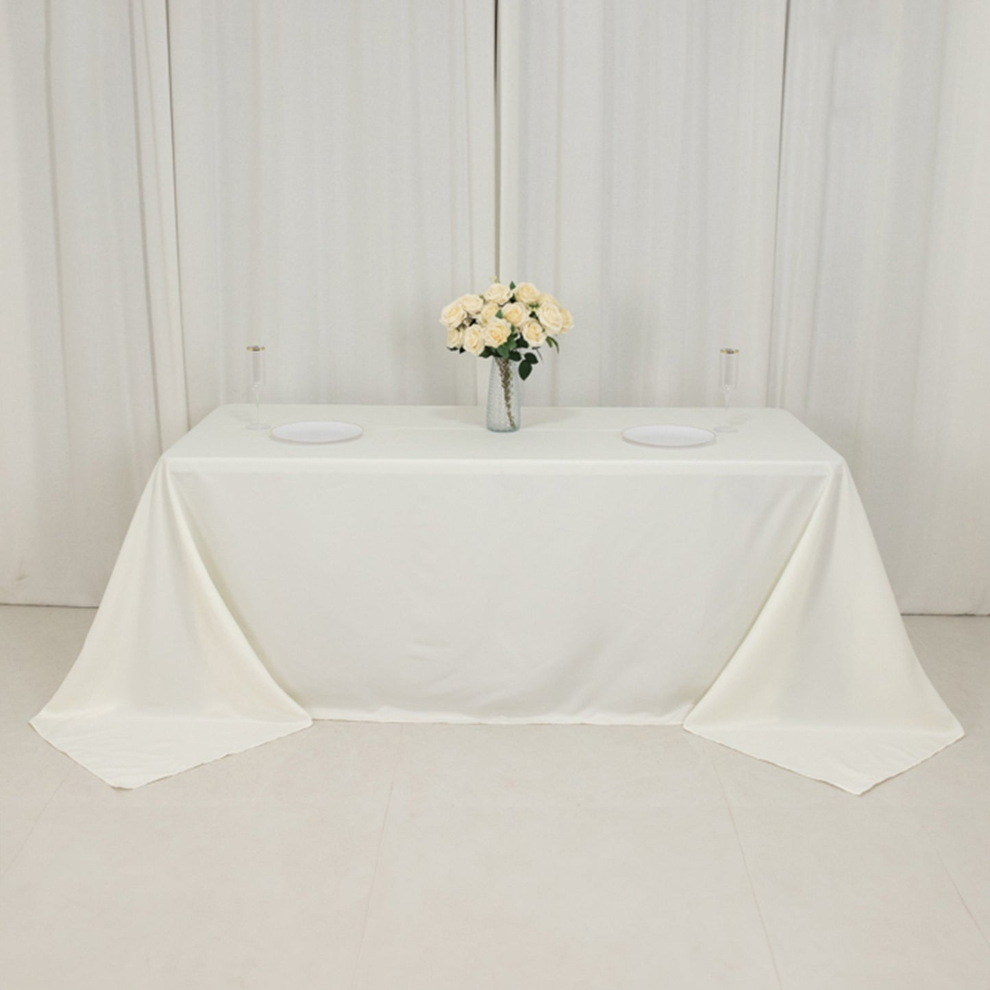 Ivory fire retardant tablecloth for 6-foot table with floor-length drop.