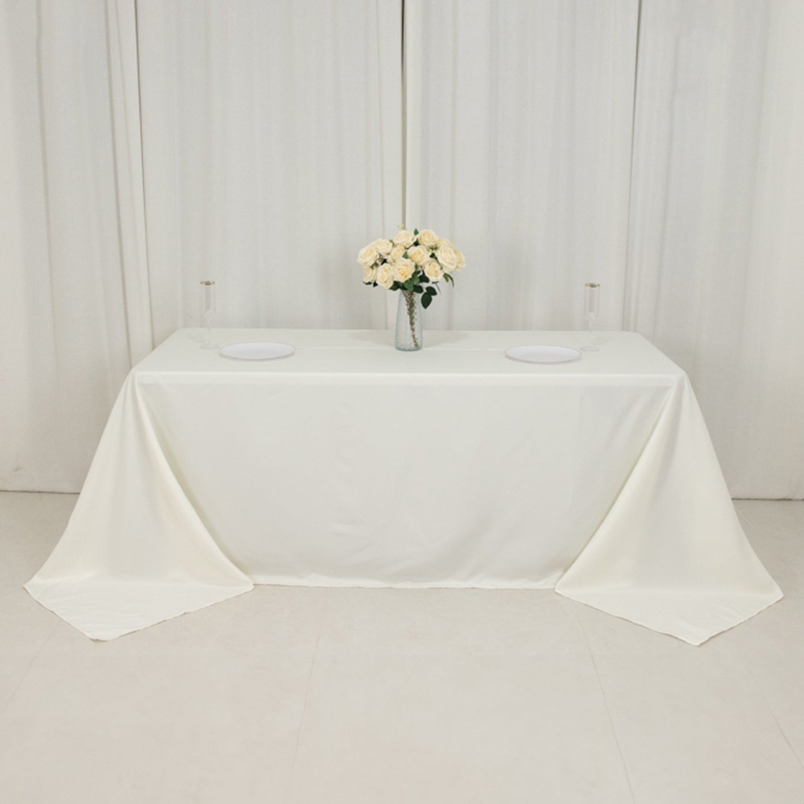 Ivory fire retardant tablecloth for 6-foot table with floor-length drop.
