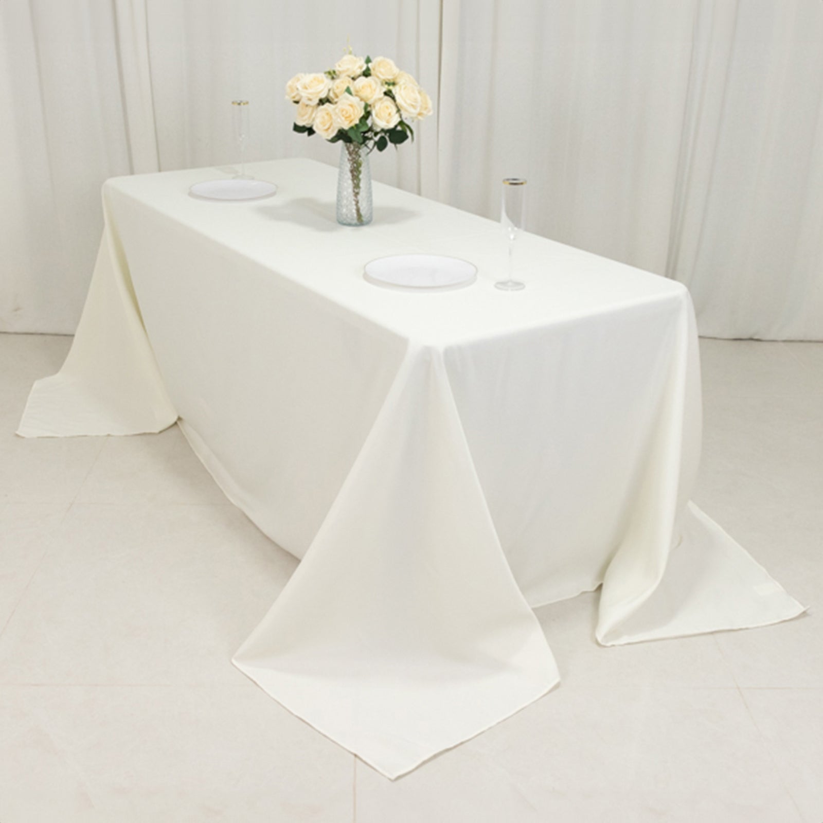 Ivory fire retardant seamless tablecloth for 6-foot table with floor-length drop.