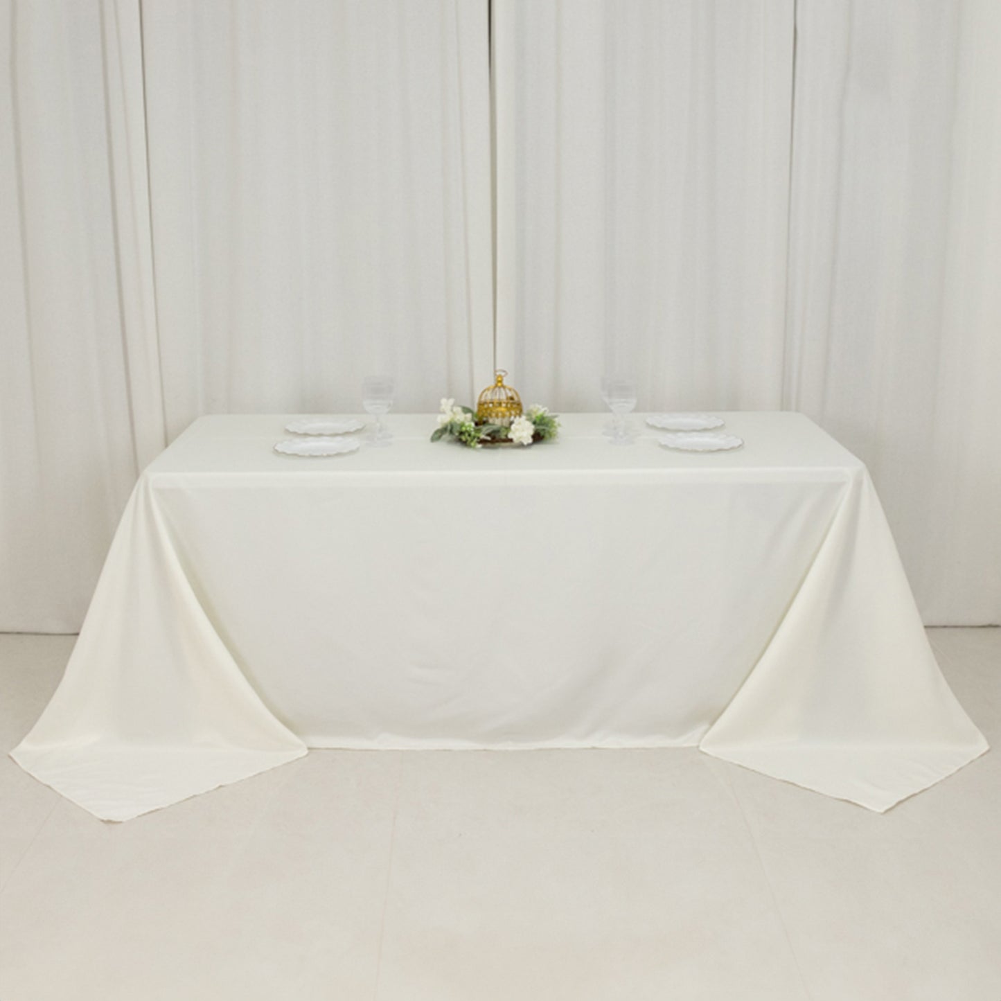 Ivory seamless tablecloth for a 6-foot table with floor-length drop.
