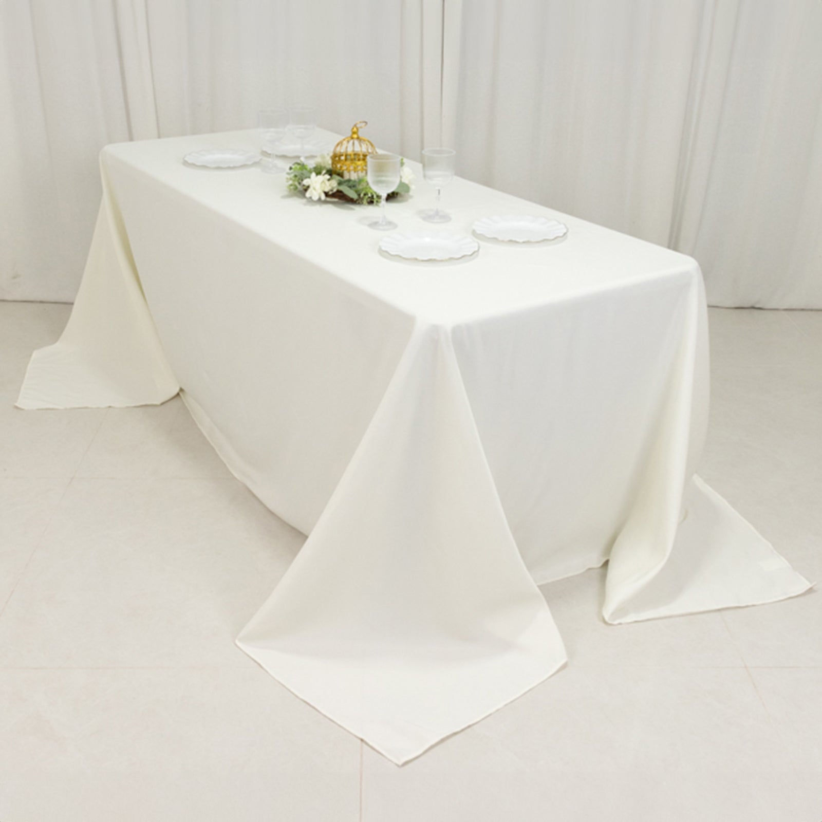 Ivory fire retardant tablecloth for 6-foot table with floor-length drop.