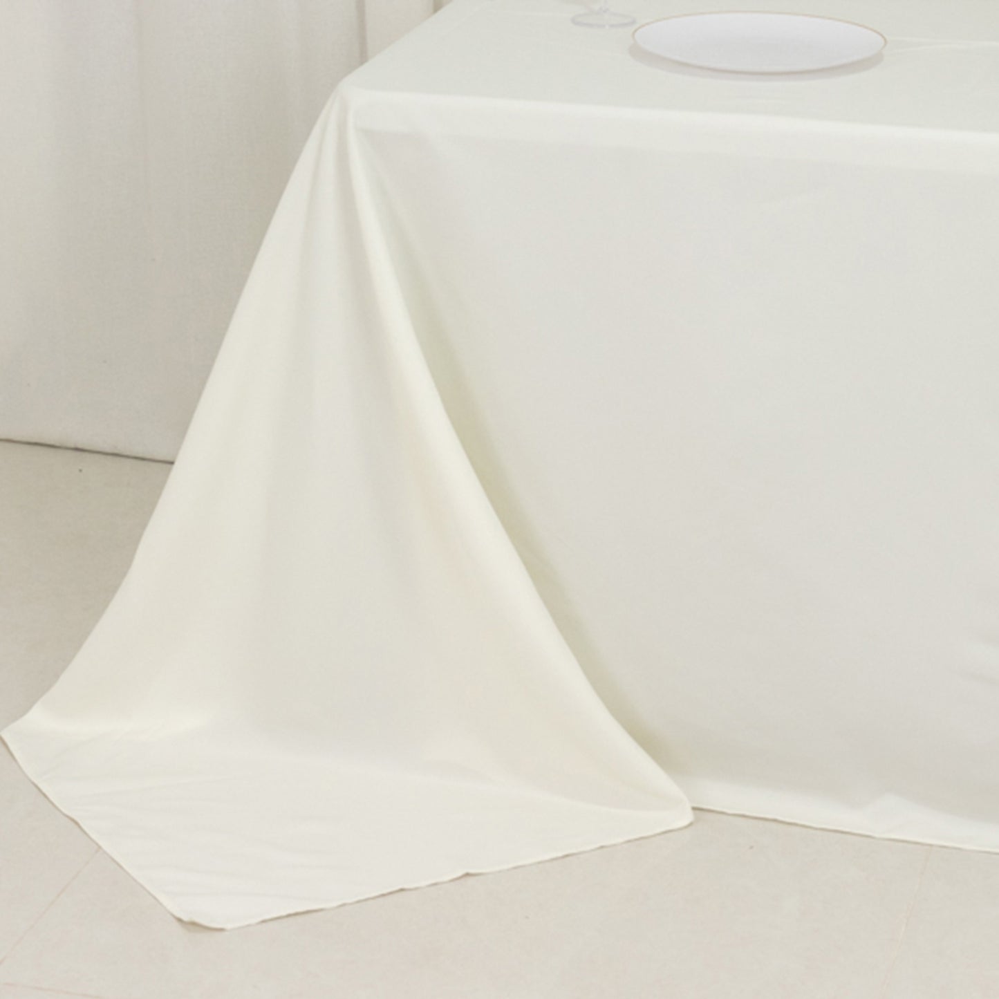 Ivory fire retardant tablecloth for 6-foot table with floor-length drop.