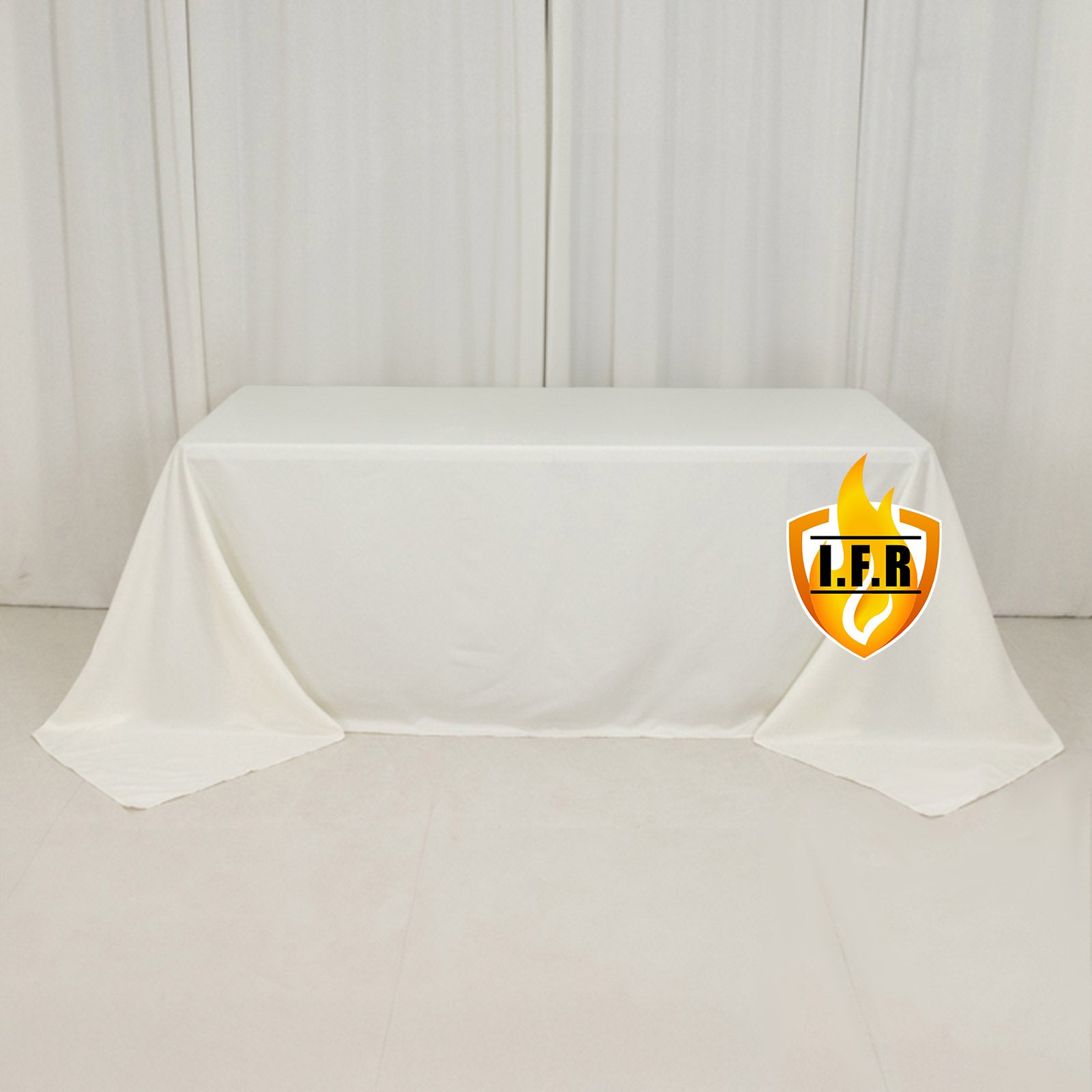Ivory fire retardant tablecloth for 6-foot table with floor-length drop.