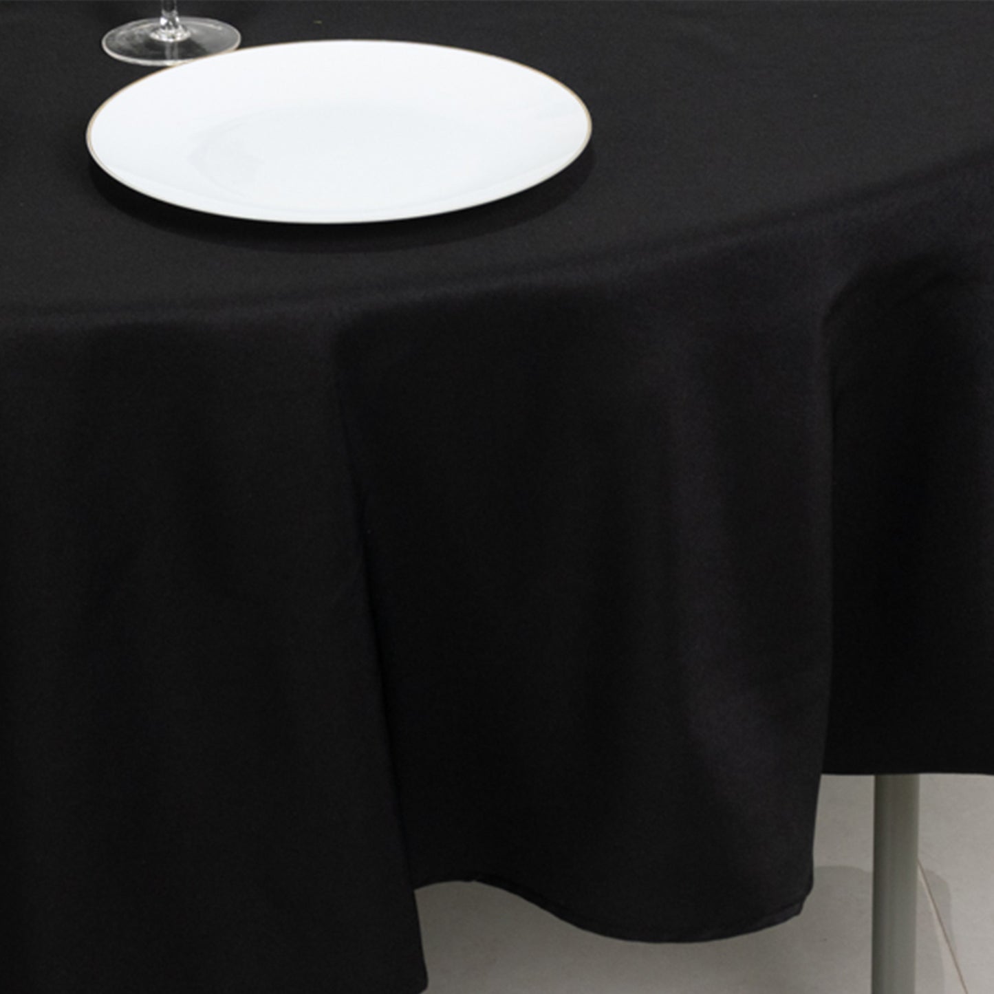 Black fire retardant round tablecloth on a table.